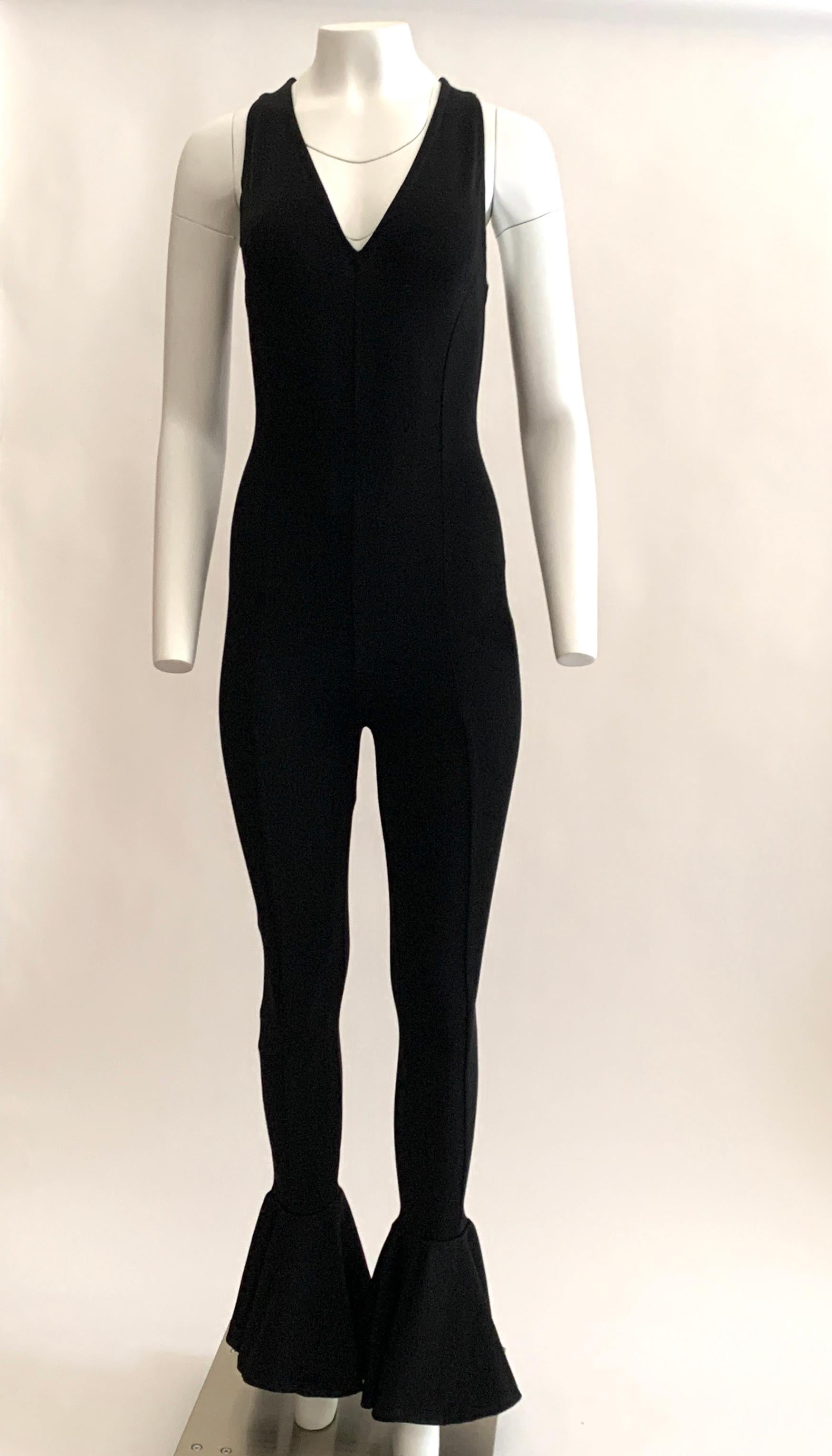 Gianni Versace Couture vintage 1990s black knit sleeveless fit and flare jumpsuit with deep v neck at front and wide opening at ankle. Seams run from top to bottom at front, back and sides to create an amazing long look. Back zip and hook and loop