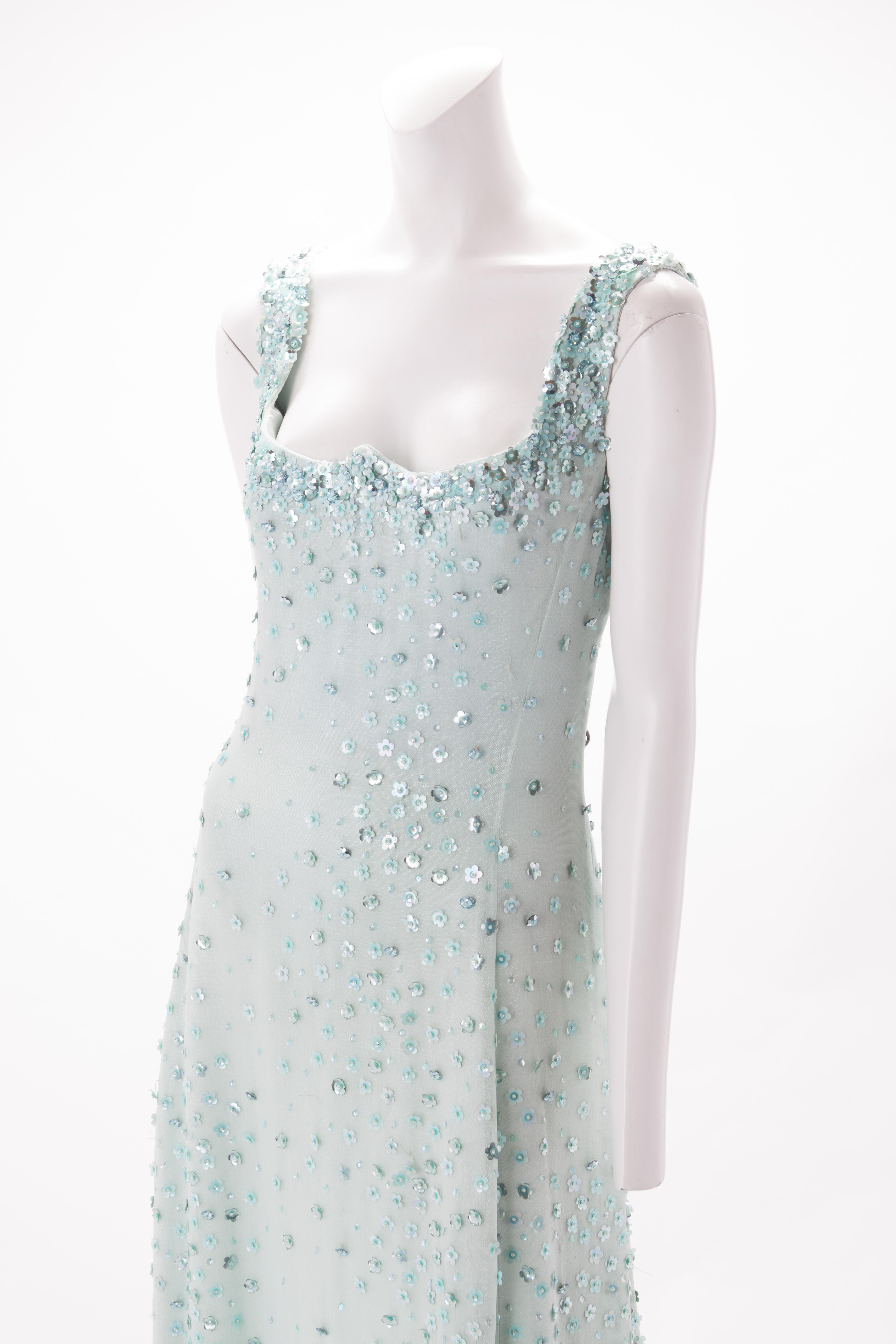 Gianni Versace Seafoam Green Silk Chiffon Gown with Floral Applique, 1995.
Gown with boned bodice and inverted sweetheart neckline. Dense applique embellishment on shoulder straps and bust, and cascading down throughout the length of the gown. Fully