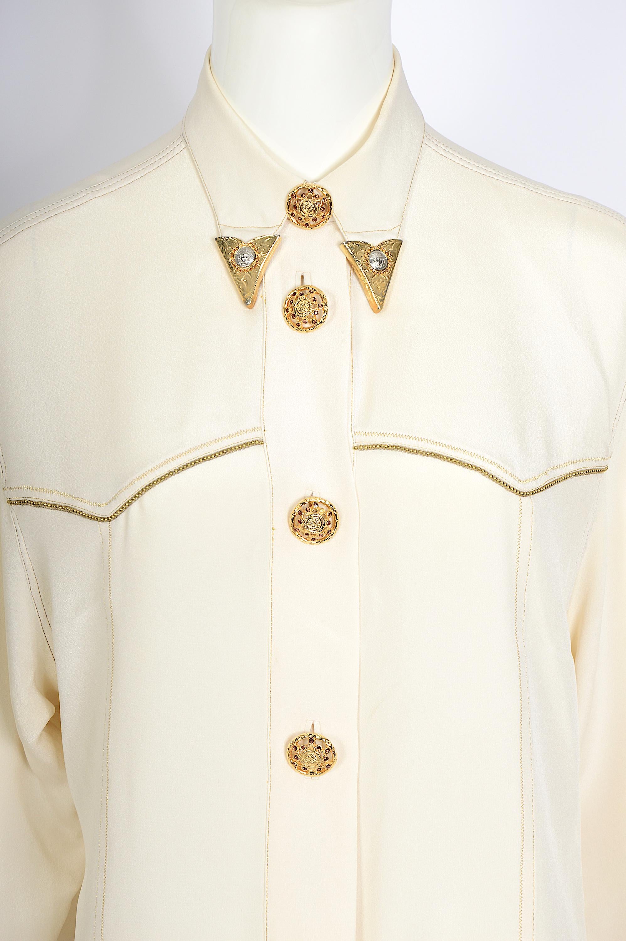 
Verlaine Vintage is introducing a beautiful cream silk blouse from the famous Gianni Versace Fall/Winter 1992 iconic Miss S&M collection – a personal favorite. 
As seen on Claudia Schiffer. 
This fantastic Gianni Versace Couture  blouse is still in