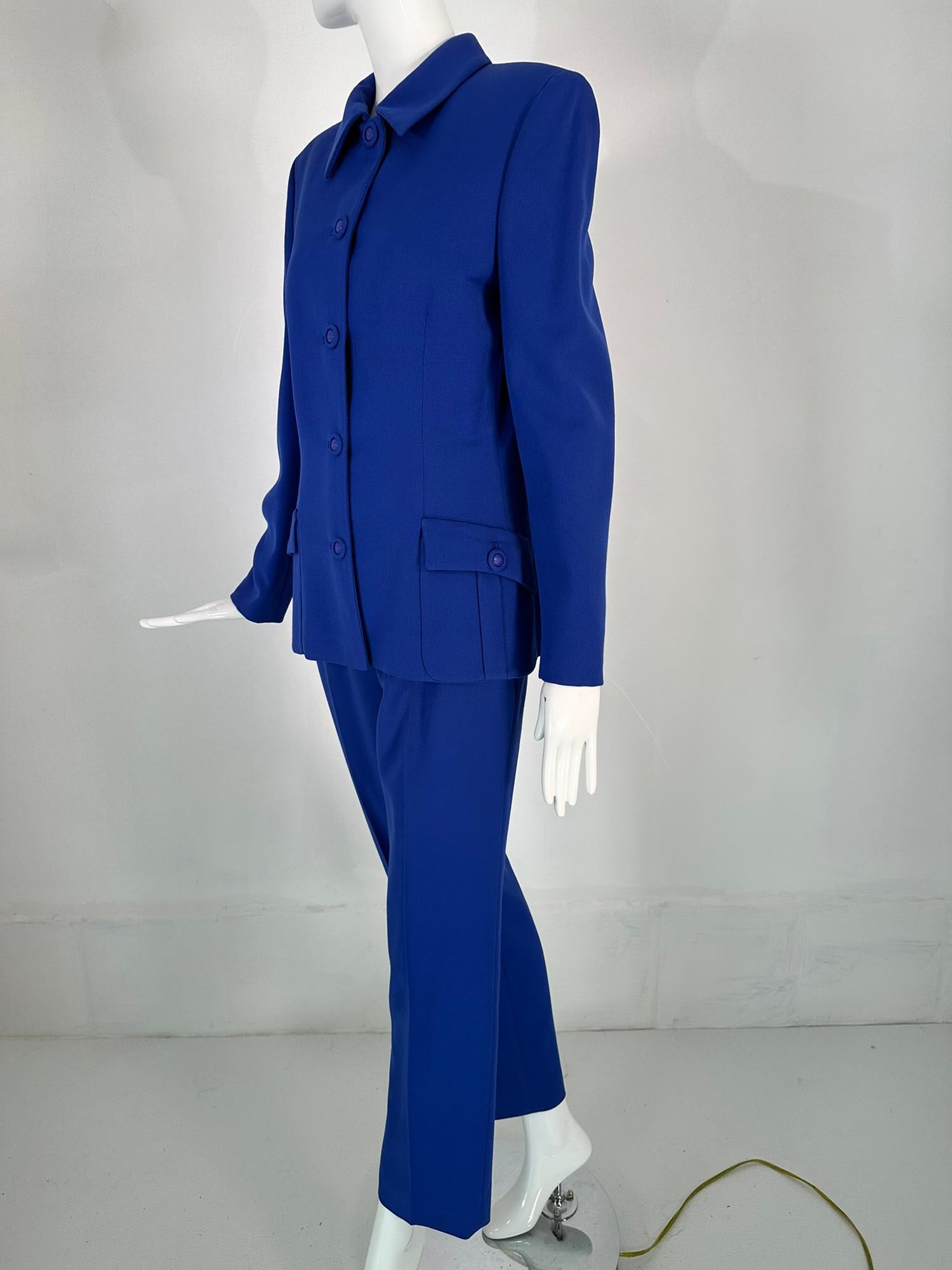 Gianni Versace Couture F/W 1995 royal blue wool twill pant suit. Beautifully tailored jacket that closes at the front with Medusa head centered self buttons. The collar can be worn buttoned to the top or with the collar worn down. Long sleeves have