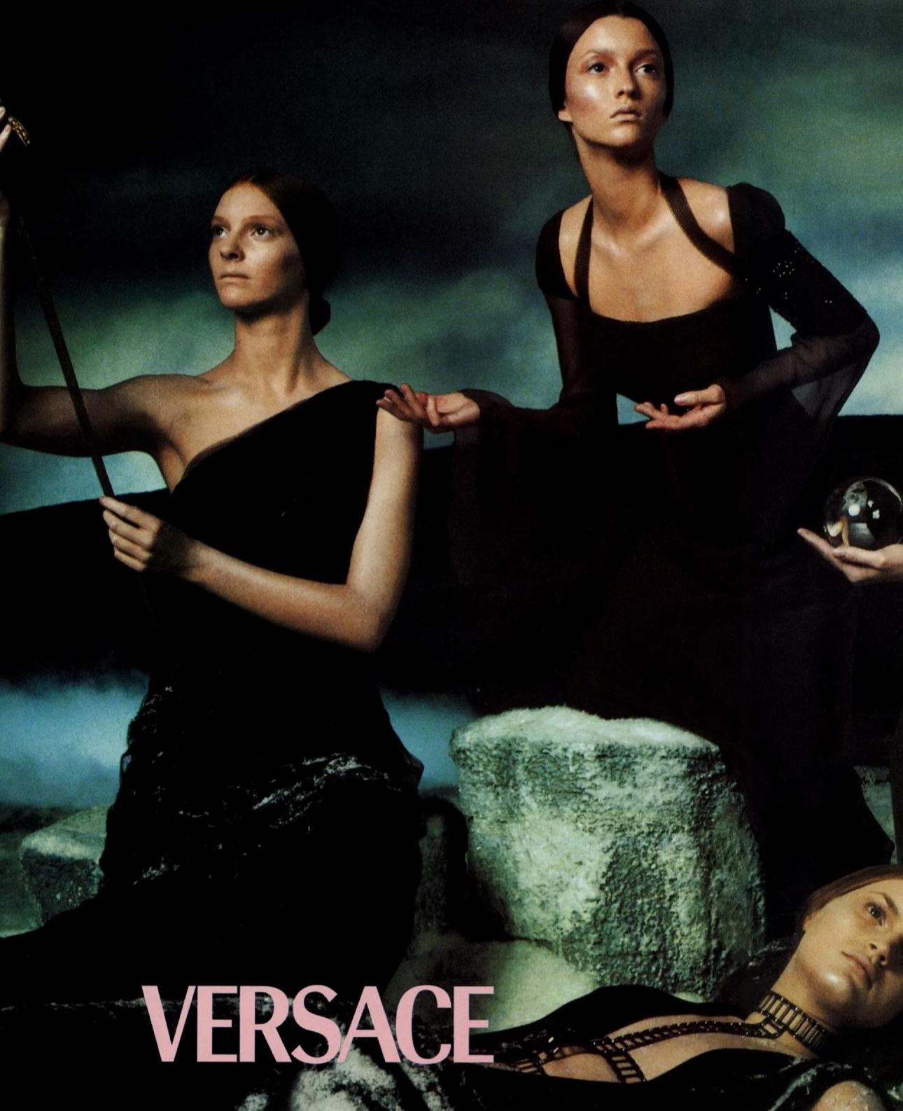 - Gianni Versace Couture evening dress 
- Sold by Skof.Archive
- Creative direction by Donatella Versace 
- Fall-Winter 1998 
- Bias-cut steel grey puffed shoulders Antique-style chain link halterneck and cuff on one sleeve, embellished with