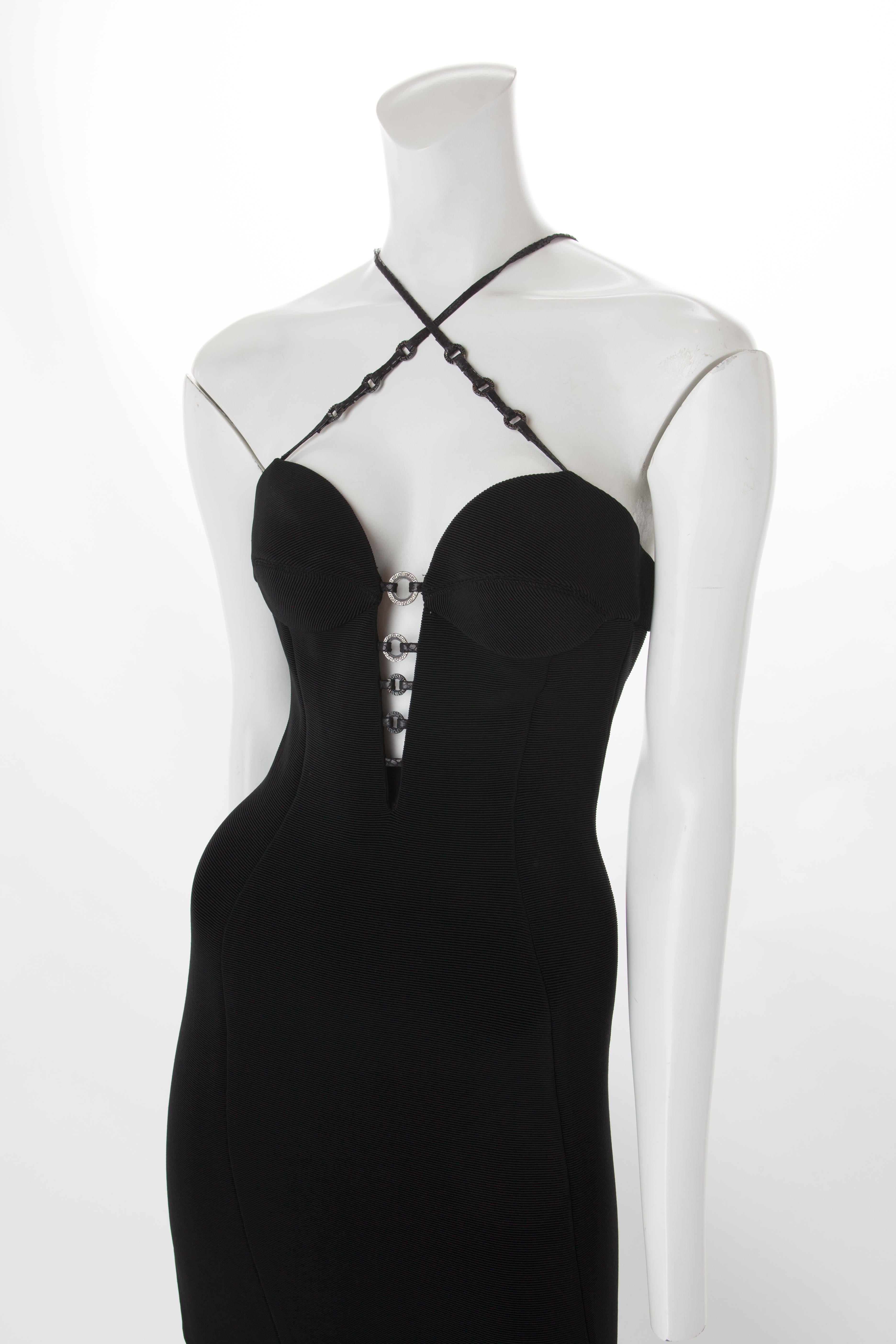 Gianni Versace Couture Long Black Bodycon Dress with Metal Ring Detail, 1995.
Cups at bust in self-fabric with graduated branded metal rings to create a plunging 