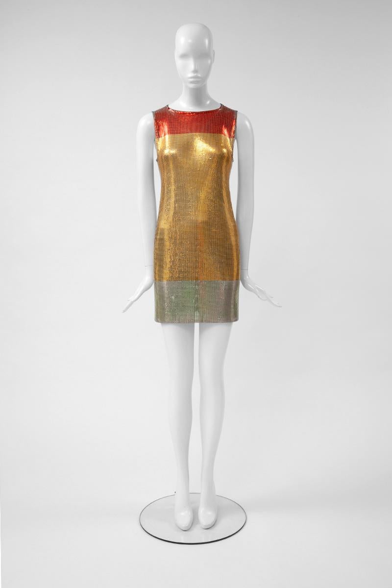 From the Fall-Winter 1996-1997 collection, this couture chainmail mesh mini dress is one of the rare examples of Gianni Versace metal creations which became one of his iconic trademarks. Labeled an Italian size 42 (US 4-6), this hand painted color