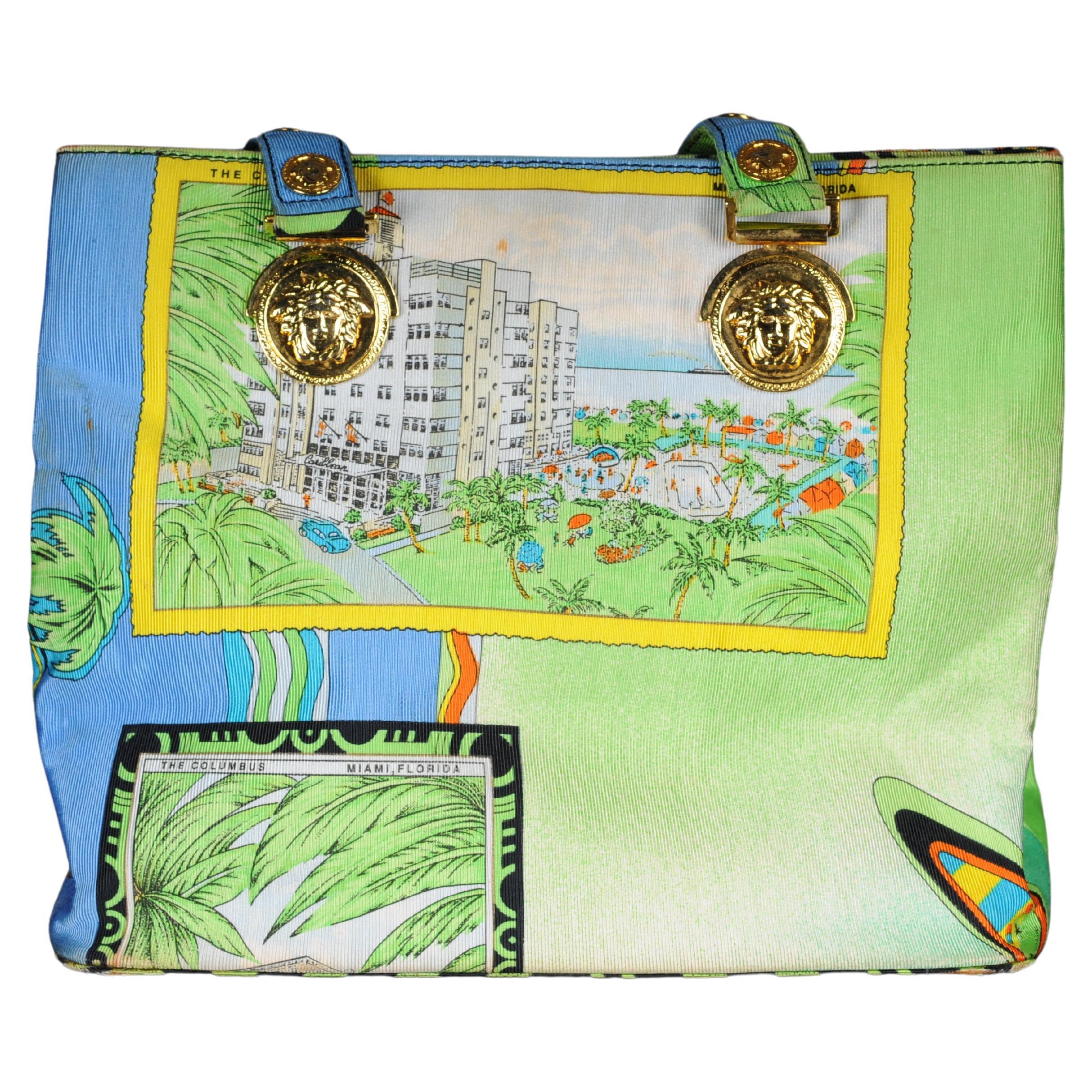 Gianni Versace Miami large silk shoulder bag from 1993 with Medusa medallions,

South Beach Miami print of tropical vintage ocean front themes can be seen throughout with pop art Miami and Florida lettering.
Handle slightly damaged