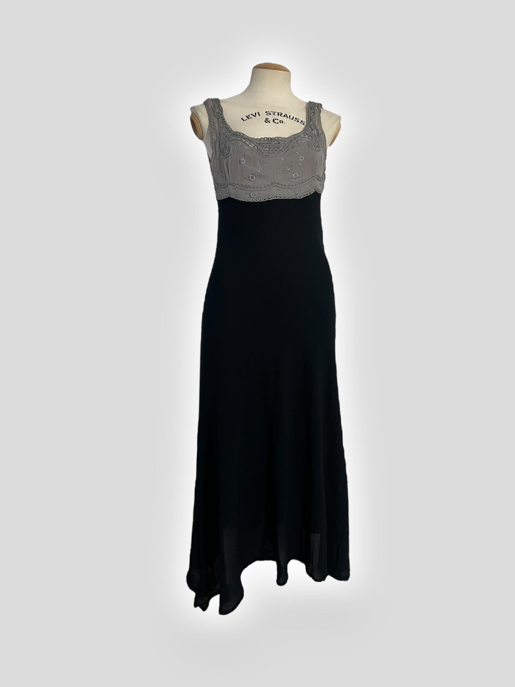 A rare and exquisite couture piece from Gianni Versace’s Spring/Summer 1997 runway collection. This midi-length dress features delicate grey lace embroidery at the bust, showcasing the house’s signature craftsmanship and attention to detail. The