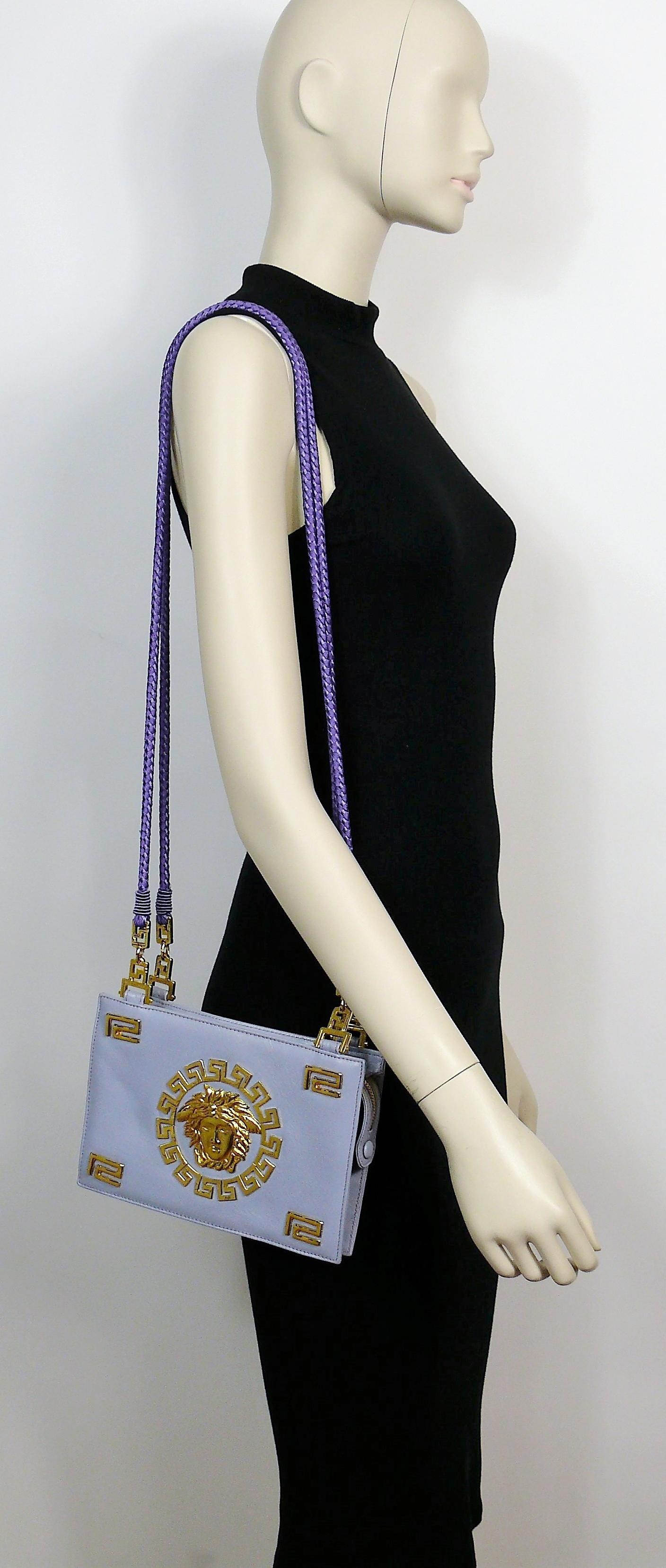 GIANNI VERSACE vintage rare lavender blue leather shoulder bag embellished with iconic gold toned MEDUSA head and 
ancient Greek friezes.

This bag features :
- Lavender blue leather body.
- Medusa head and Greek friezes at front.
- Gold toned