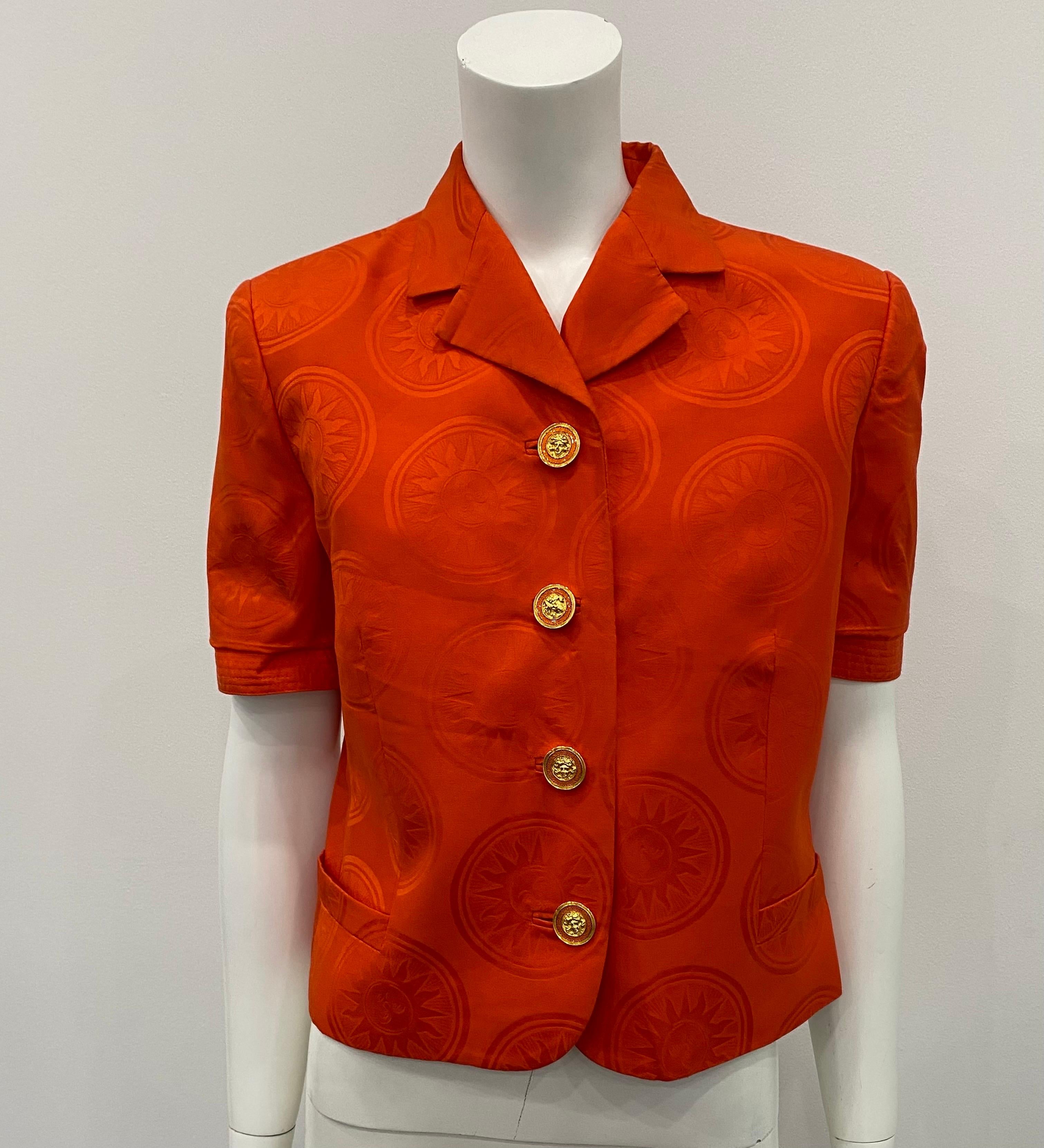 Gianni Versace Couture Orange Silk Damask Sun Pattern Short Sleeve Jacket/Top - Circa 90’s. This fantastic and highly collectible piece has an incredibly vibrant orange damask color, 4 front gold and orange spectacular Versace buttons, short sleeve