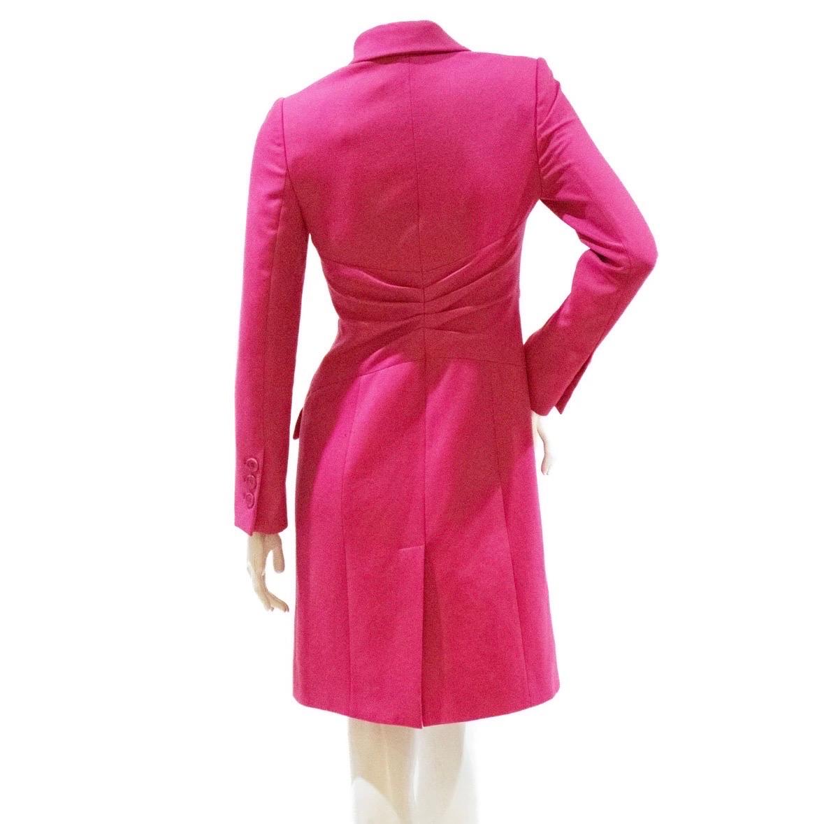 Fuchsia blazer coat by Gianni Versace
2009 collection
Made in Italy
Double-breasted v-neck
Contrasting neckline fabrics (silk and wool)
Fitted waist with knife pleats
Hook and eye front closure 
Split front with reveal
Monochromatic pink cuff