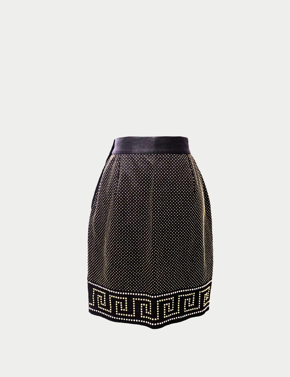Turn heads with this Gianni Versace black and gold studded mini skirt, a striking design that celebrates the brand’s bold aesthetic. Crafted in Italy, the skirt features a sleek black base adorned with all-over gold-tone stud embellishments that