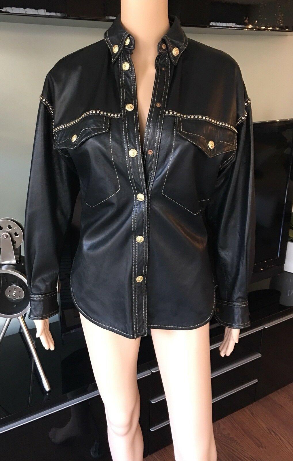 GIANNI VERSACE F/W 1992 Runway Vintage Embellished Leather Shirt Jacket Top IT 38

Gianni Versace leather shirt/jacket with pointed collar, dual pockets at bust, long sleeves and embellished gold-tone snap closures at front. 

About Versace: Founded