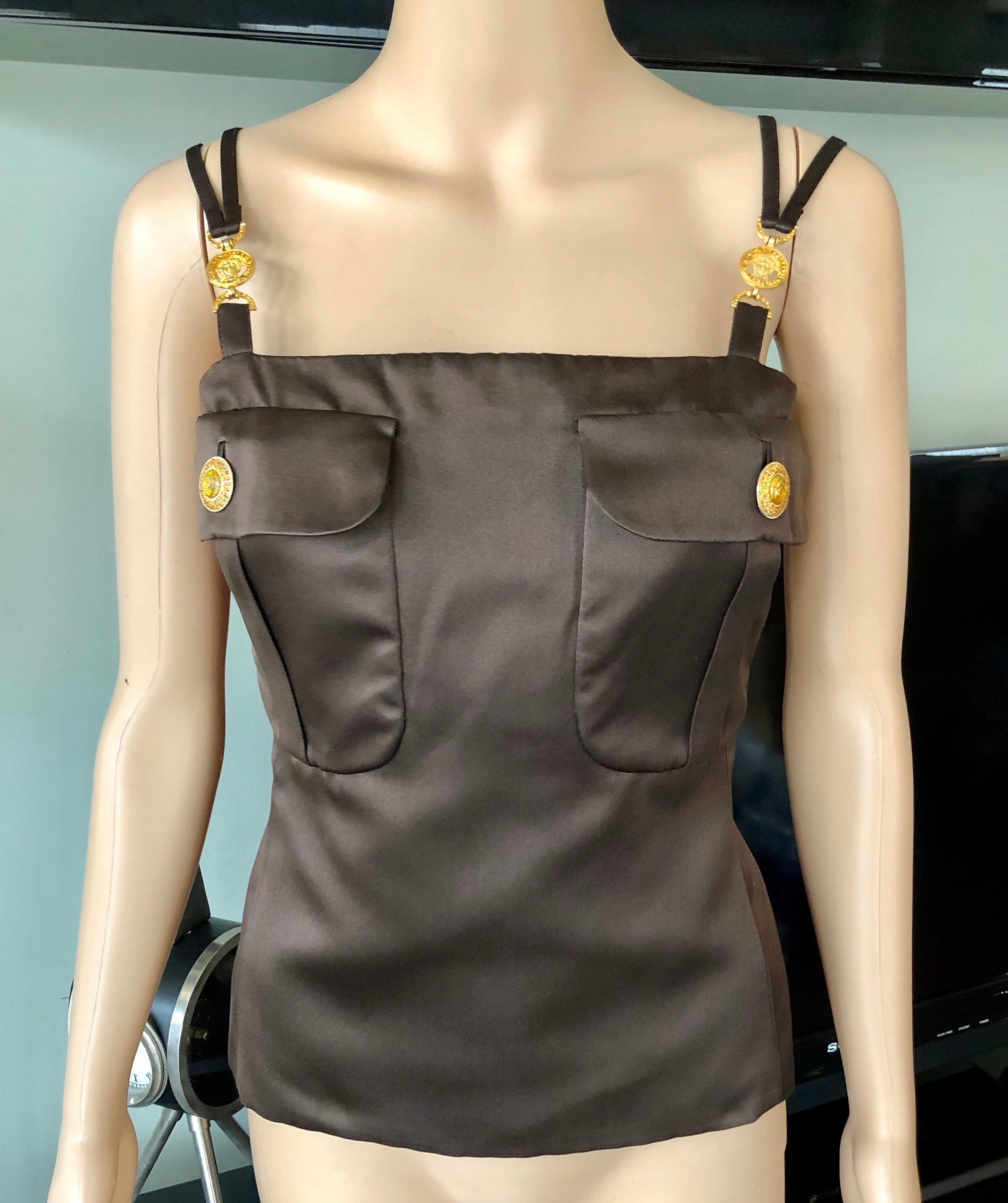 Gianni Versace F/W 1996 Runway Vintage Silk Brown Top IT 42

Gianni Versace silk brown top featuring logo embellishments at straps and concealed zip closure at back.

