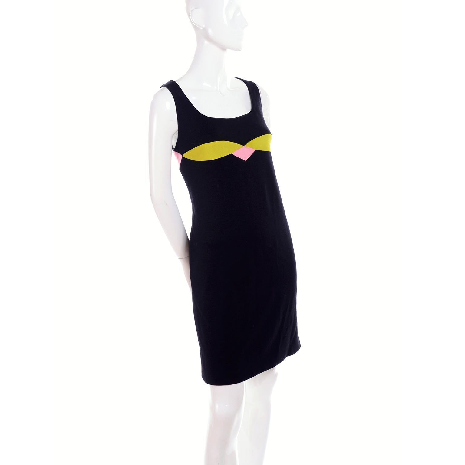 Gianni Versace Couture Fall/Winter 1997 vintage black wool blend knit sleeveless dress with pink and chartreuse design at bustline. Fully lined, the dress closes with a back zipper and hook and eye. We are showing it on the runway in Milan as