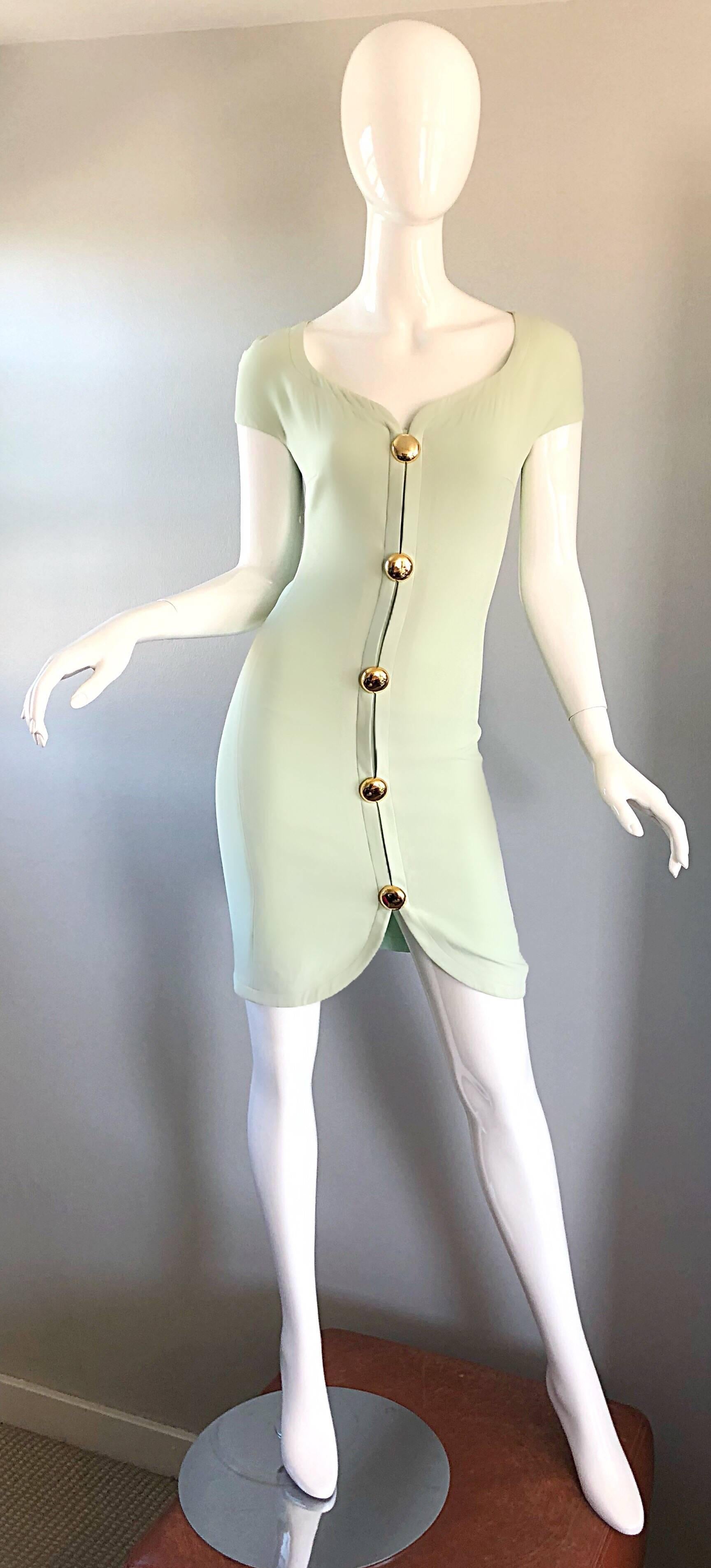 Sexy brand new with original tags vintage GIANNI VERSACE for GENNY pale mint green bodcon dress! Features a body hugging fit. Large round gold buttons up the front bodice. 
Soft rayon blend fabric. Sweetheart neckline. Perfect for any day or evening