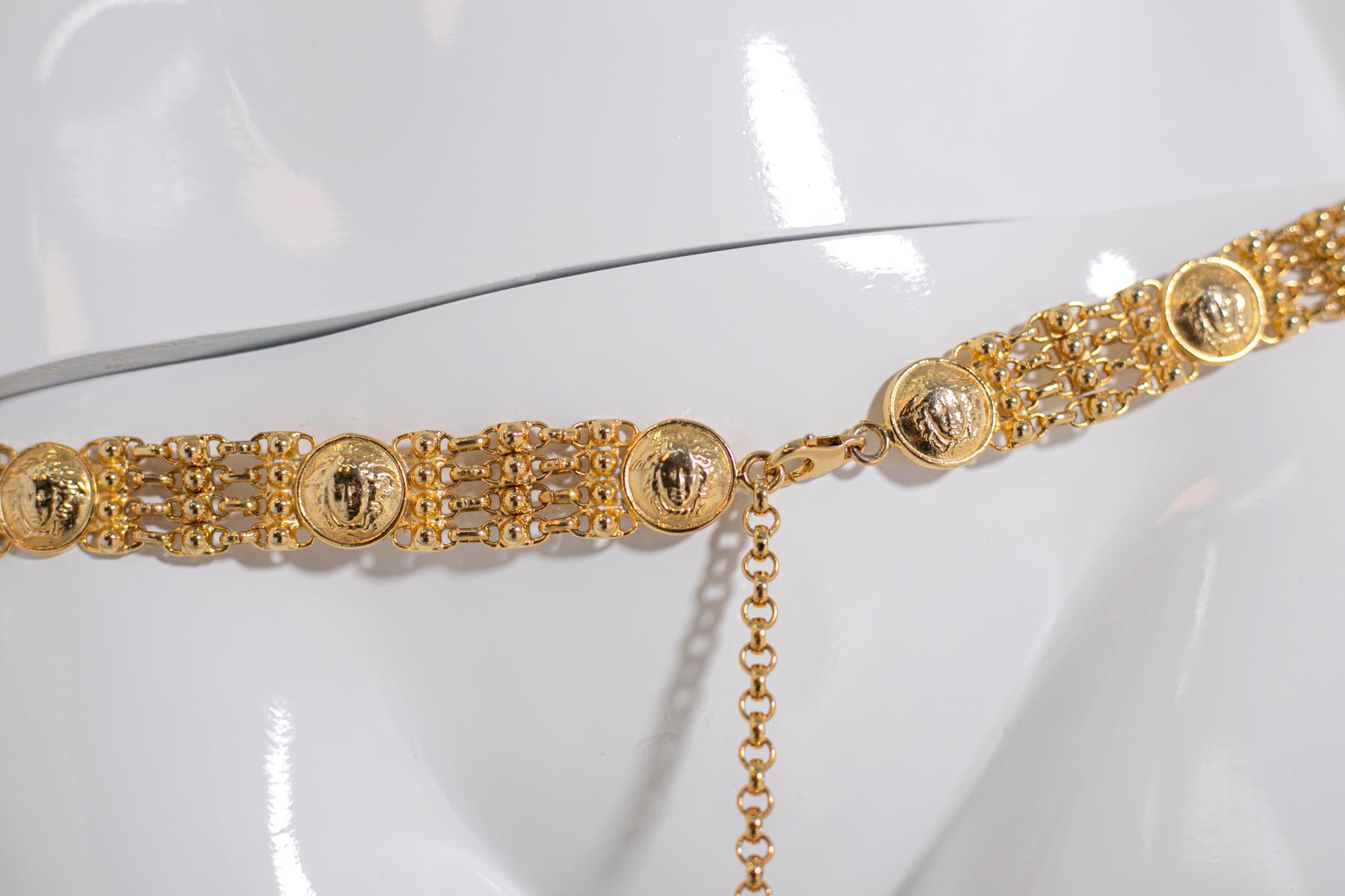 This rare belt from the 1990s's by Gianni Versace is one of the most iconic pieces in his original collection. 
The belt is beautifully composed of 16 circular handmade motifs in the shape of the goddess Medusa's head in gold and linked together by