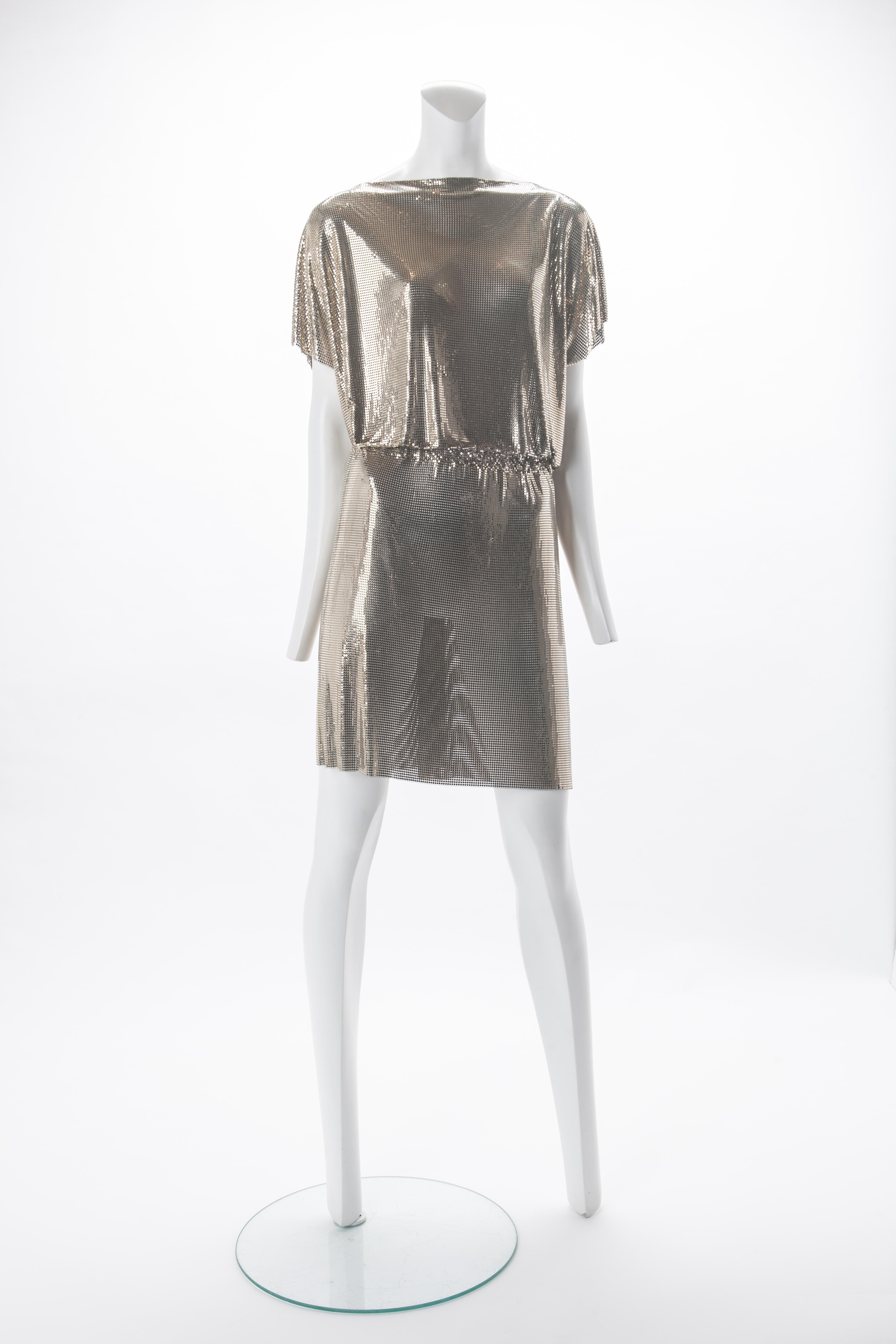 Gianni Versace Gold Oroton Dress, F/W 1994.
Boatneck gold chainmail dress with draped sleeves. Features elastic band at waist that can be adjusted from inside. 
Fits US size 4 to 8. 