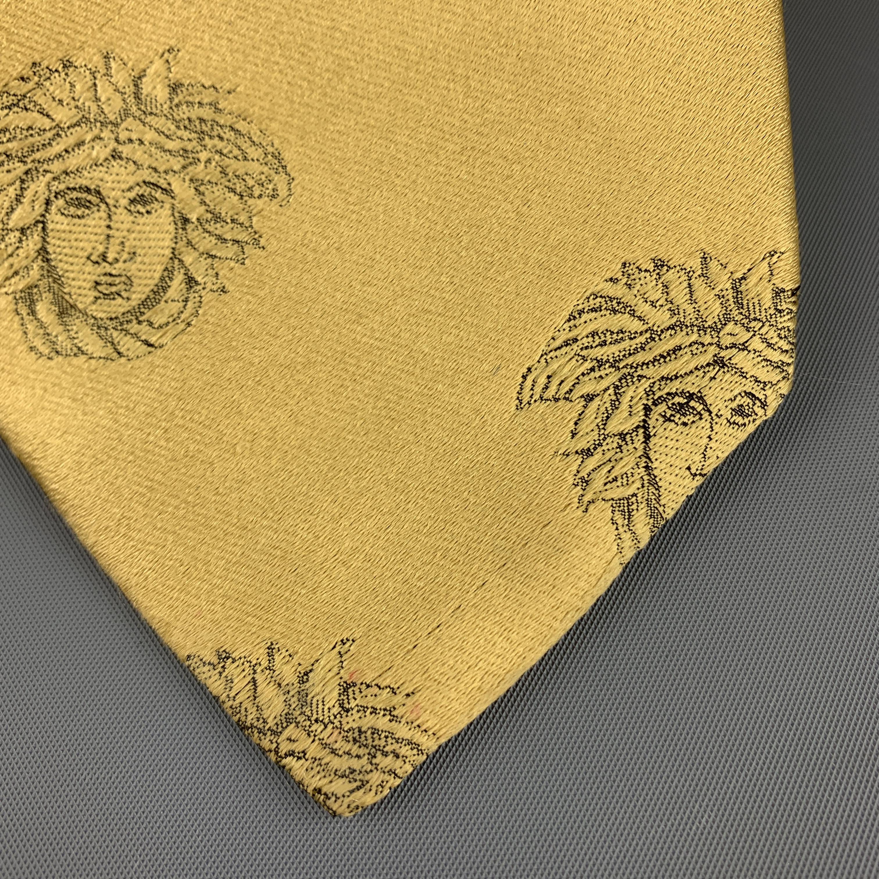 Vintage GIANNI VERSACE tie comes in gold silk with all over Medusa head graphic print. Imperfections shown in detail shot. As-is. Made in Italy.
 
Good Pre-Owned Condition.
 
Width: 3.5 in.