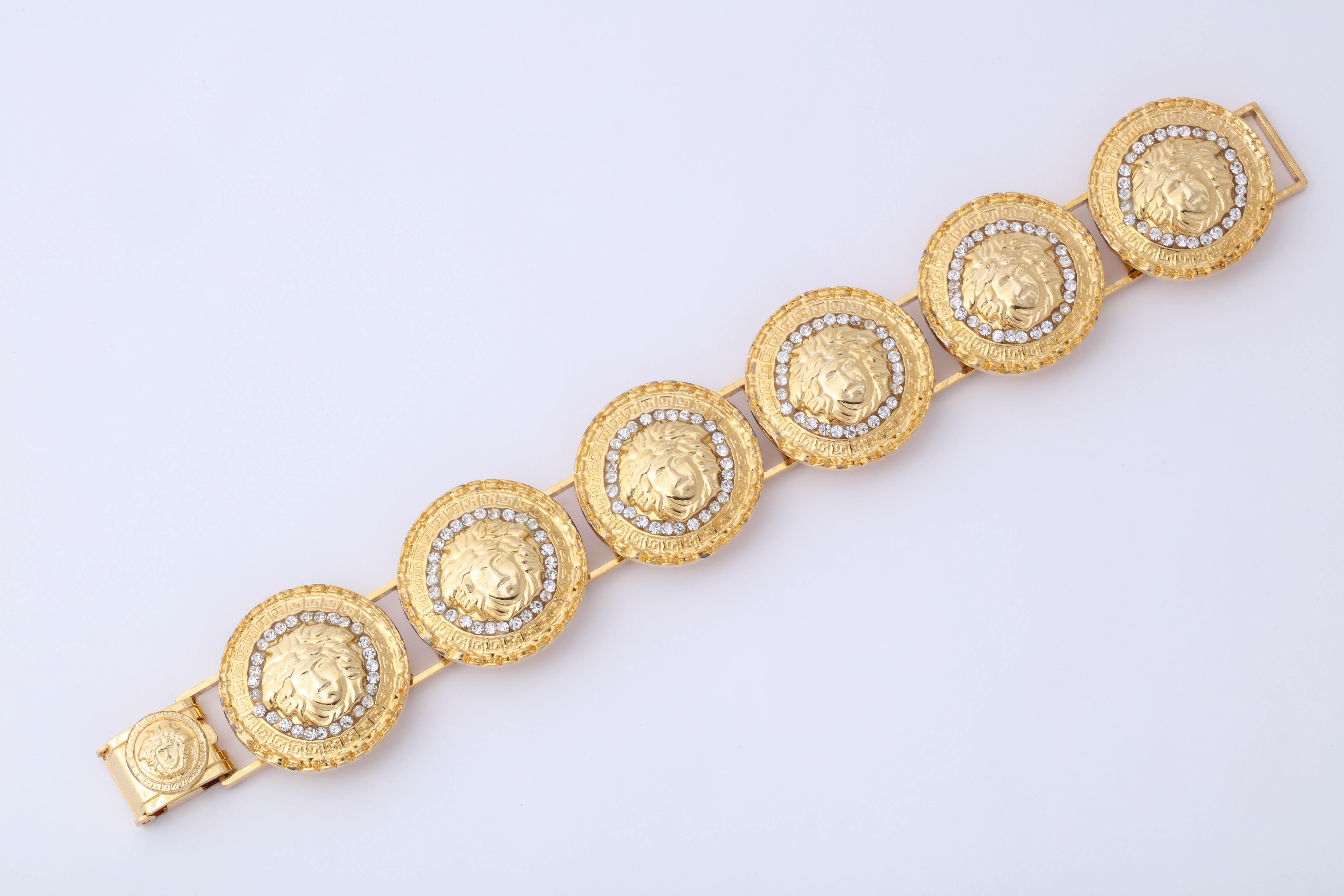 Gianni Versace gold toned bracelet with rhinestones and 6 iconic Medusa motifs.