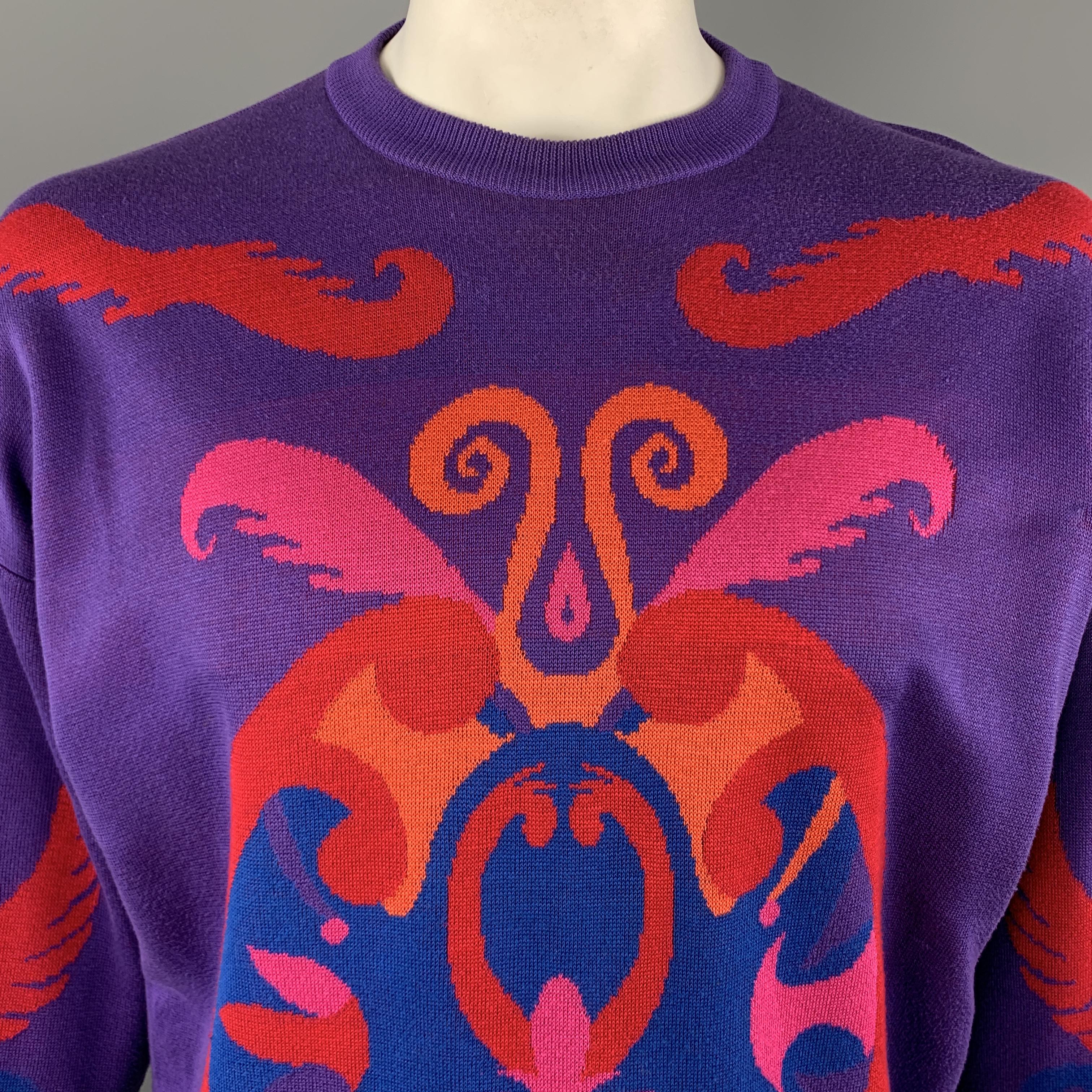 Vintage INSTANTE by GIANNI VERSACE pullover sweater comes in purple cotton knit with a vibrant pink, orange, and blue baroque style print throughout and crewneck. Minor wear and pulling throughout. As-is. Made in Italy.

Good Pre-Owned
