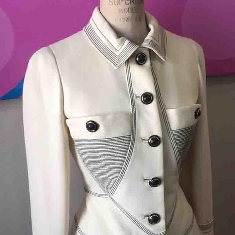Gianni Versace vintage pieces are always a wonder to behold. This super rare ivory wool skirt suit is a great example of the brand, while the founder was still alive. A few pricks in the fabric.
Size 38
Jacket
Across chest -  17 1/2 in.
Across waist