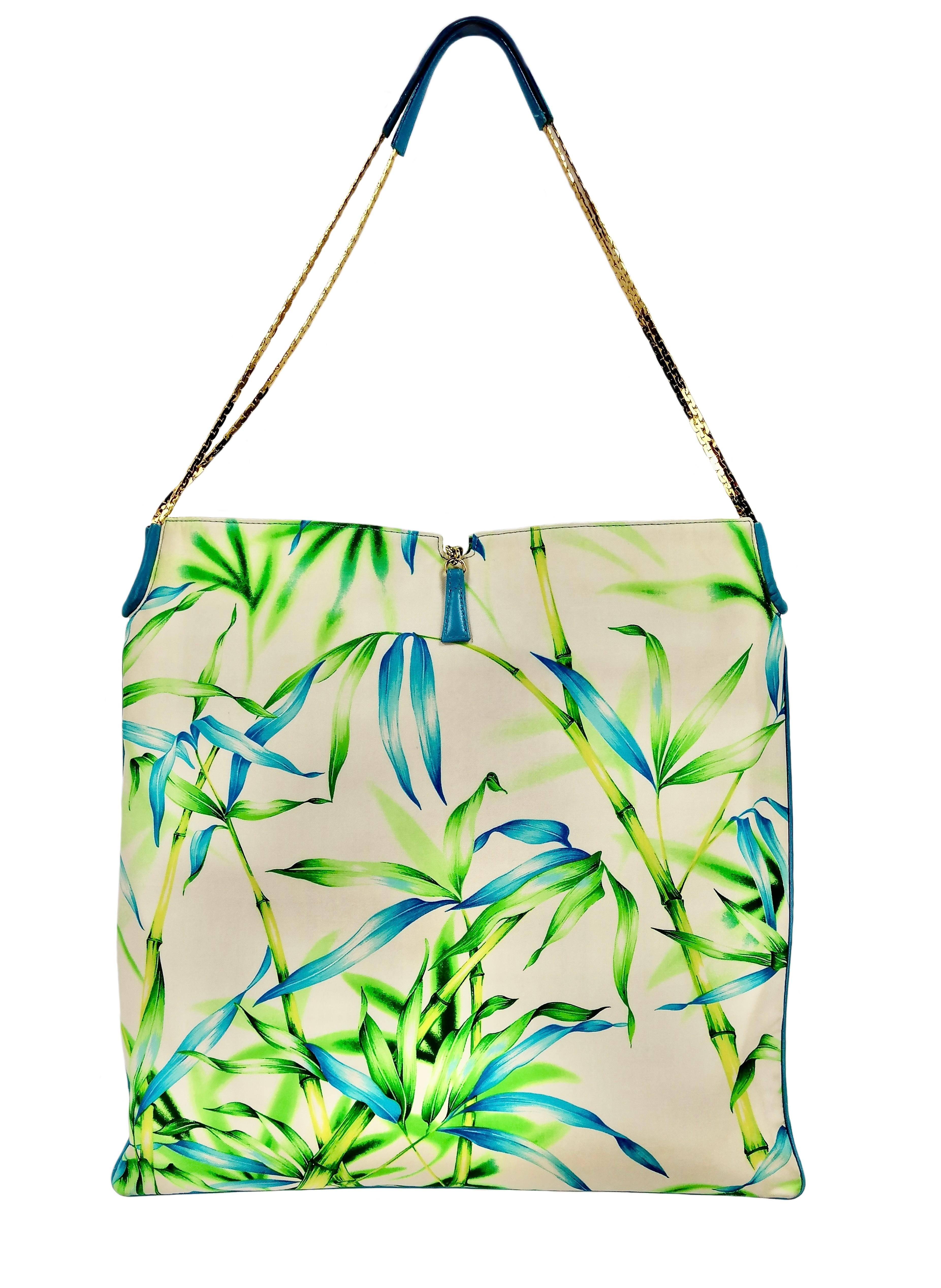 GIANNI VERSACE  jungle shoulder bag
S/S 2000 Collection
Jungle silk fabric with turquoise leather details.
Made in Italy
Measures:
cm. 39 x cm. 39
Total height cm. 65
Excellent condition with original dust bag