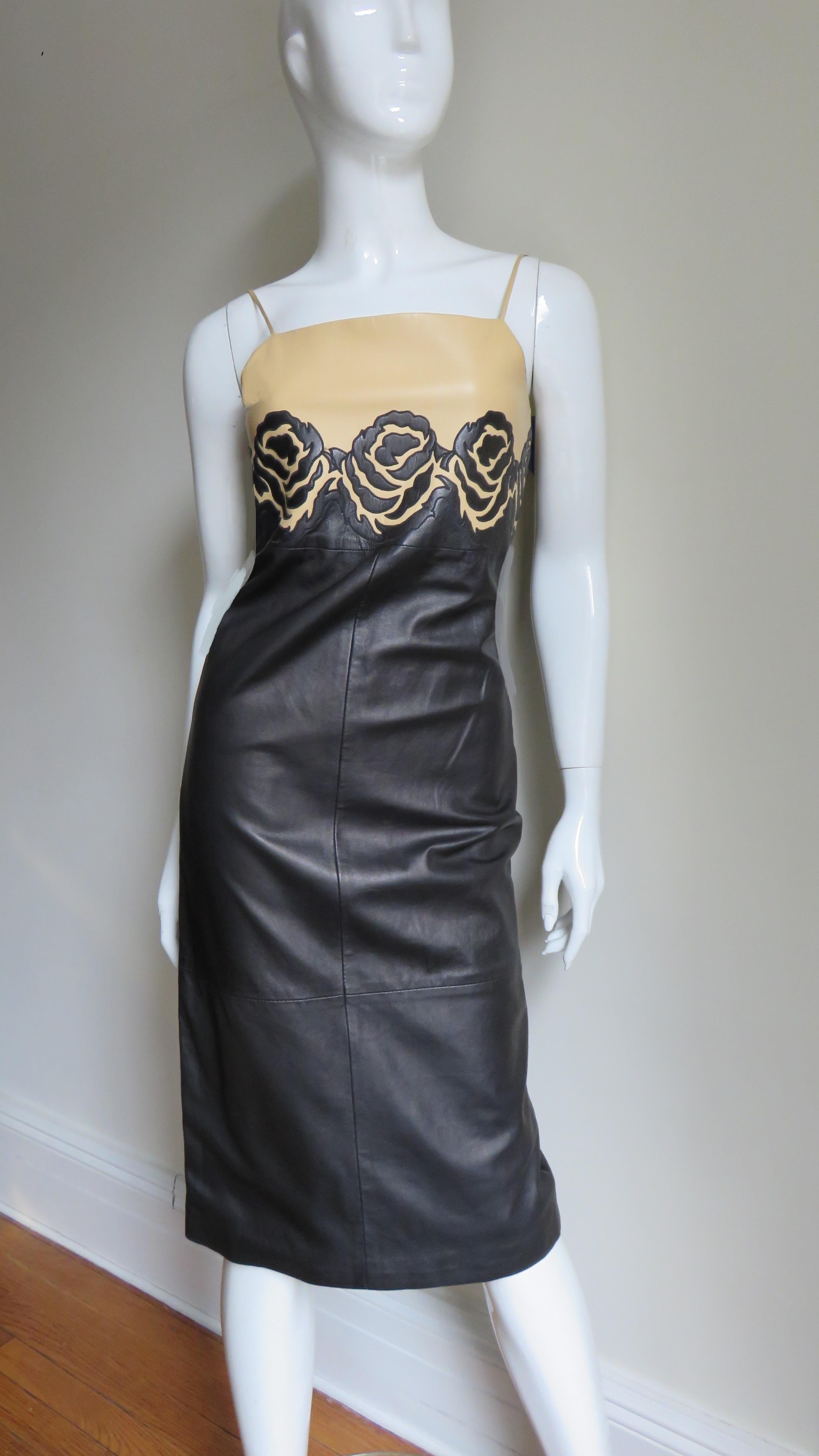 A fabulous leather dress from Gianni Versace's Isante line in beige and navy. The upper bodice is beige with spaghetti straps and the body of the dress is navy. Both are separated by a horizontal row (uninterrupted even at the back zipper) of