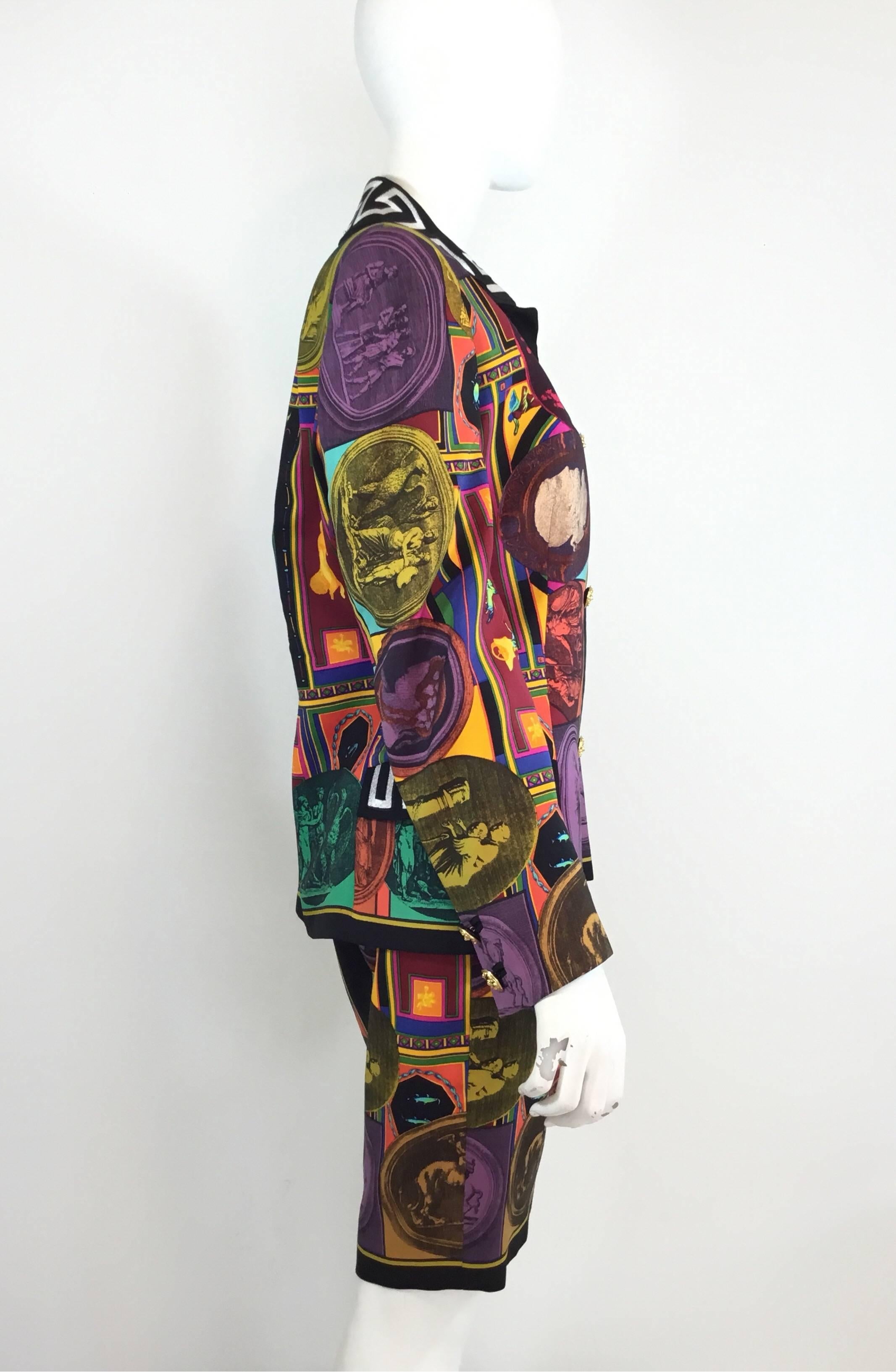 Vintage Gianni Versace skirt suit features a bright multicolored print throughout; Jacket has button closures at the front and on the sleeves, embroidered detail on the collar and on the flaps of the pockets at the waist. Skirt has a side zipper