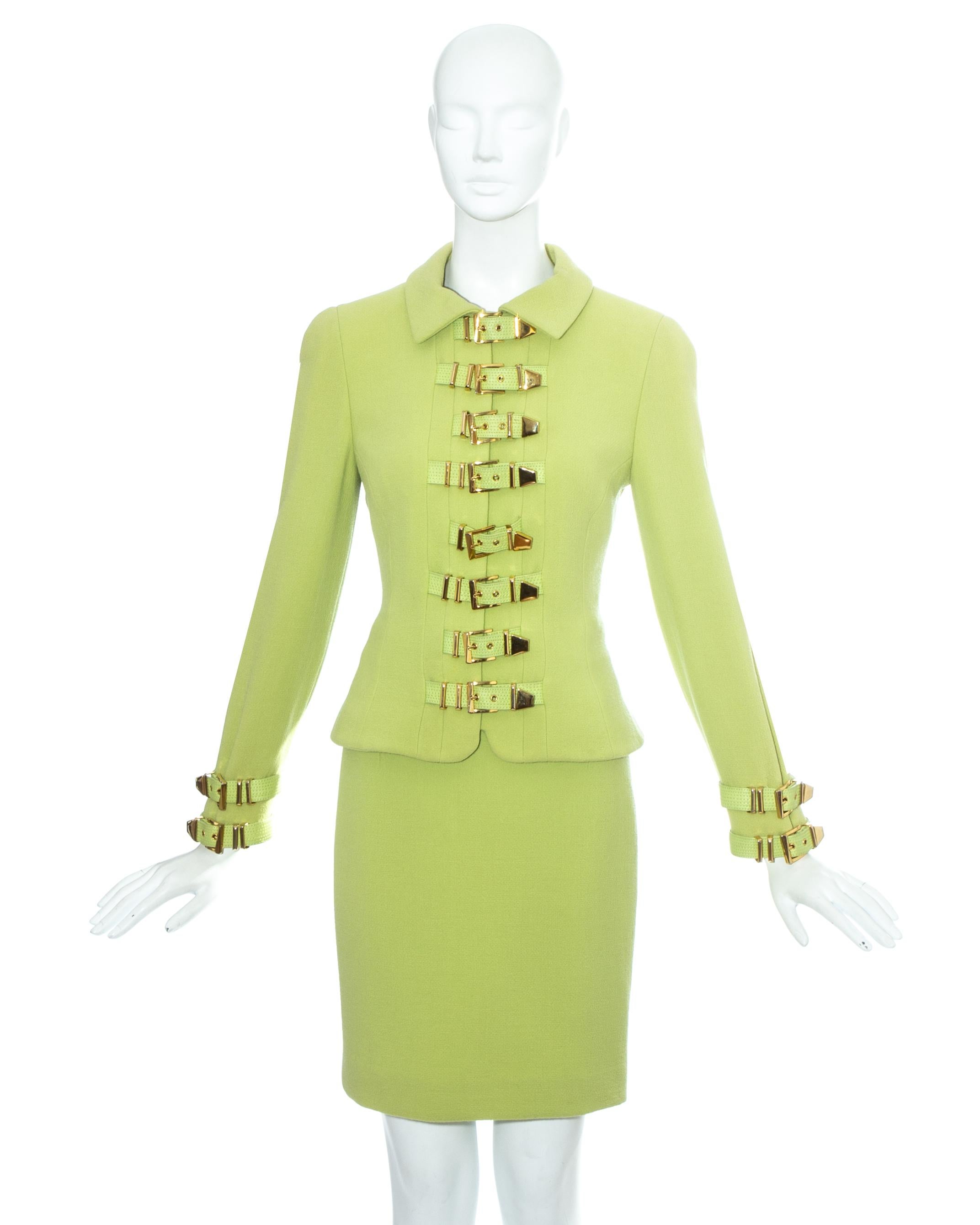 Gianni Versace; lime green wool bondage skirt suit. Structured jacket with 15 leather gold buckle fastenings, hidden zip fastening and silk lining. Sold with matching figure hugging pencil skirt.

Fall-Winter 1992

Image 5 and 6: Gianni Versace
