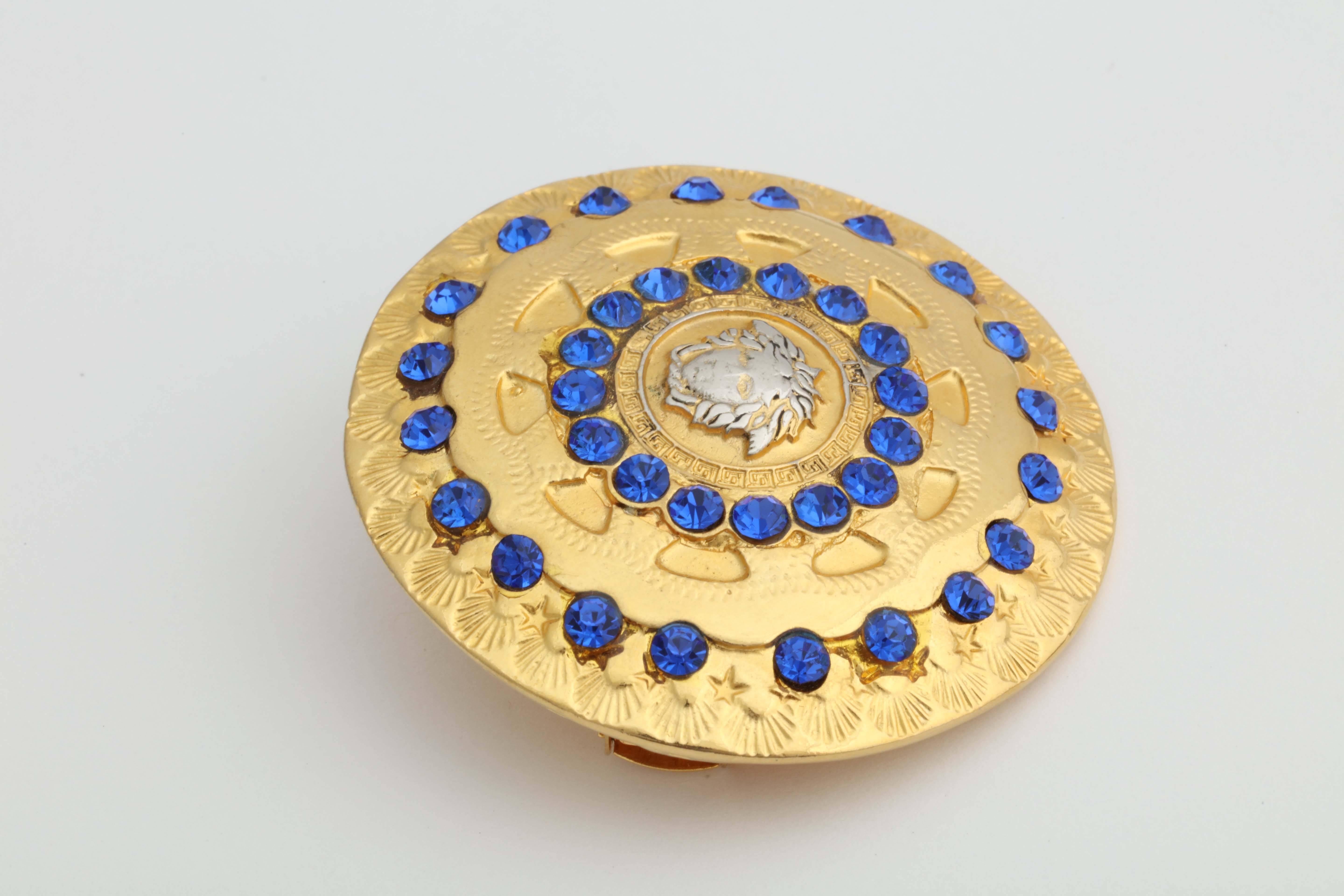 Gianni Versace gold Medusa hair pin with blue rhinestones.
Width 2 inches