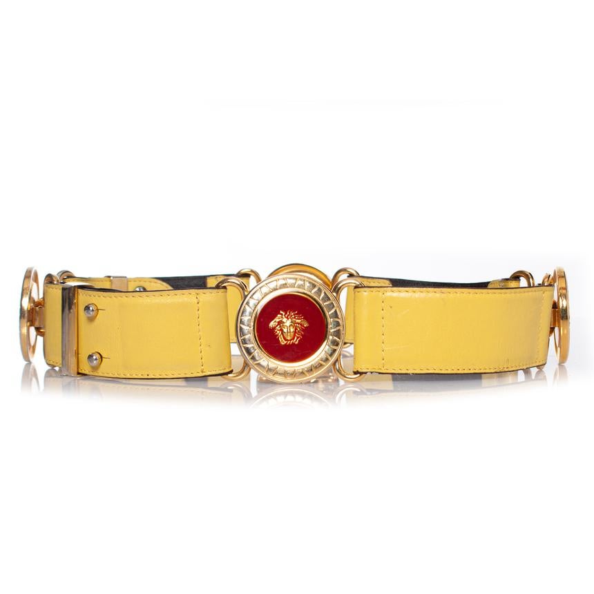 Gianni Versace, Medusa leather waist belt in yellow with multicolored medusa applications. The item has signs of wear, overall in good condition. Very rare vintage piece. (SS1993)

• CONDITION: good condition 

• SIZE: 70/28

• MEASUREMENTS: length