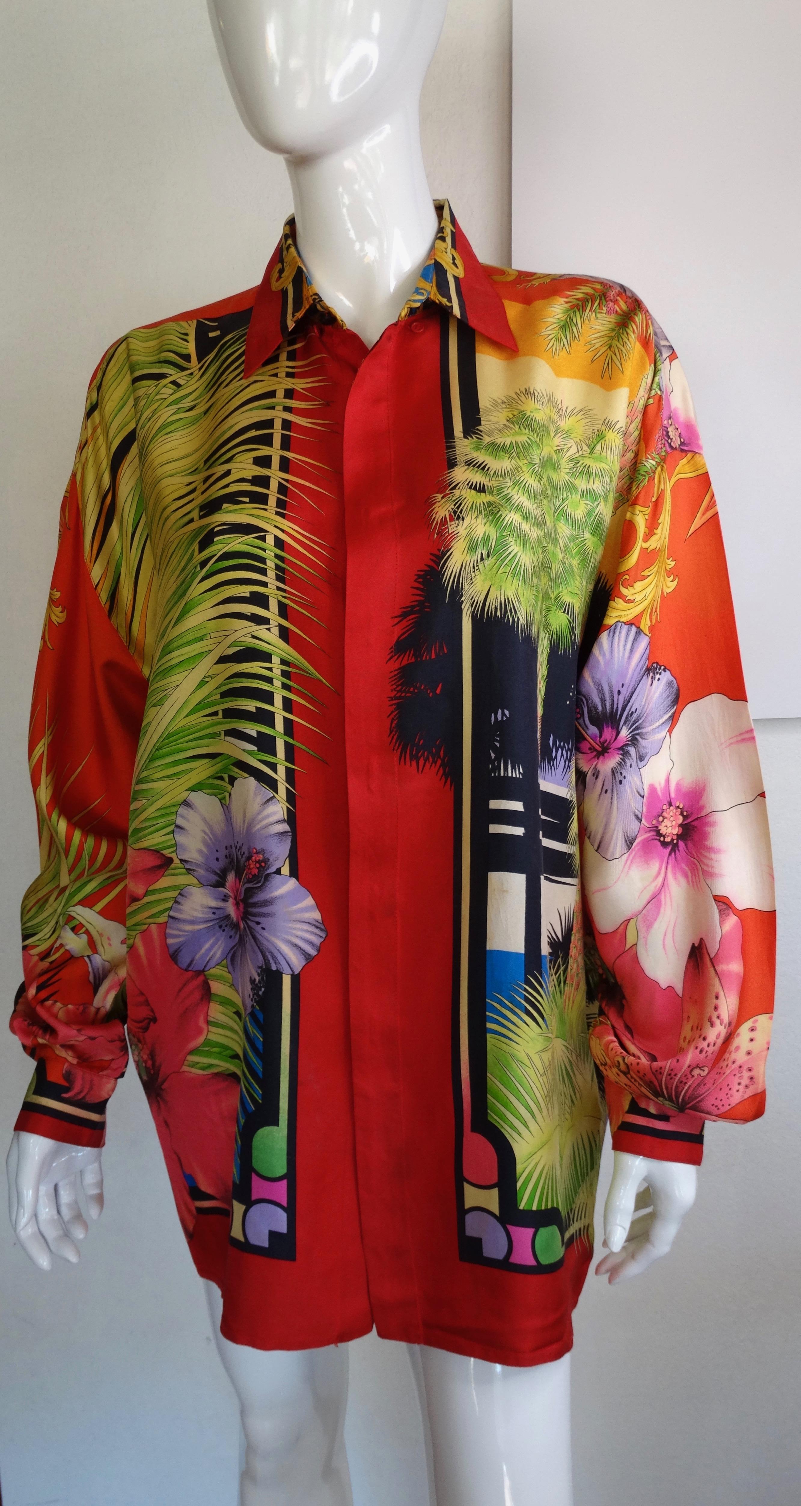 Snag yourself a piece from the Versace archives! Circa 1993 from the Miami collection, this silk shirt is a gorgeous red color and features a celestial sunset motif on the back with Versace's iconic Baroque designs and rolling clouds. Included on