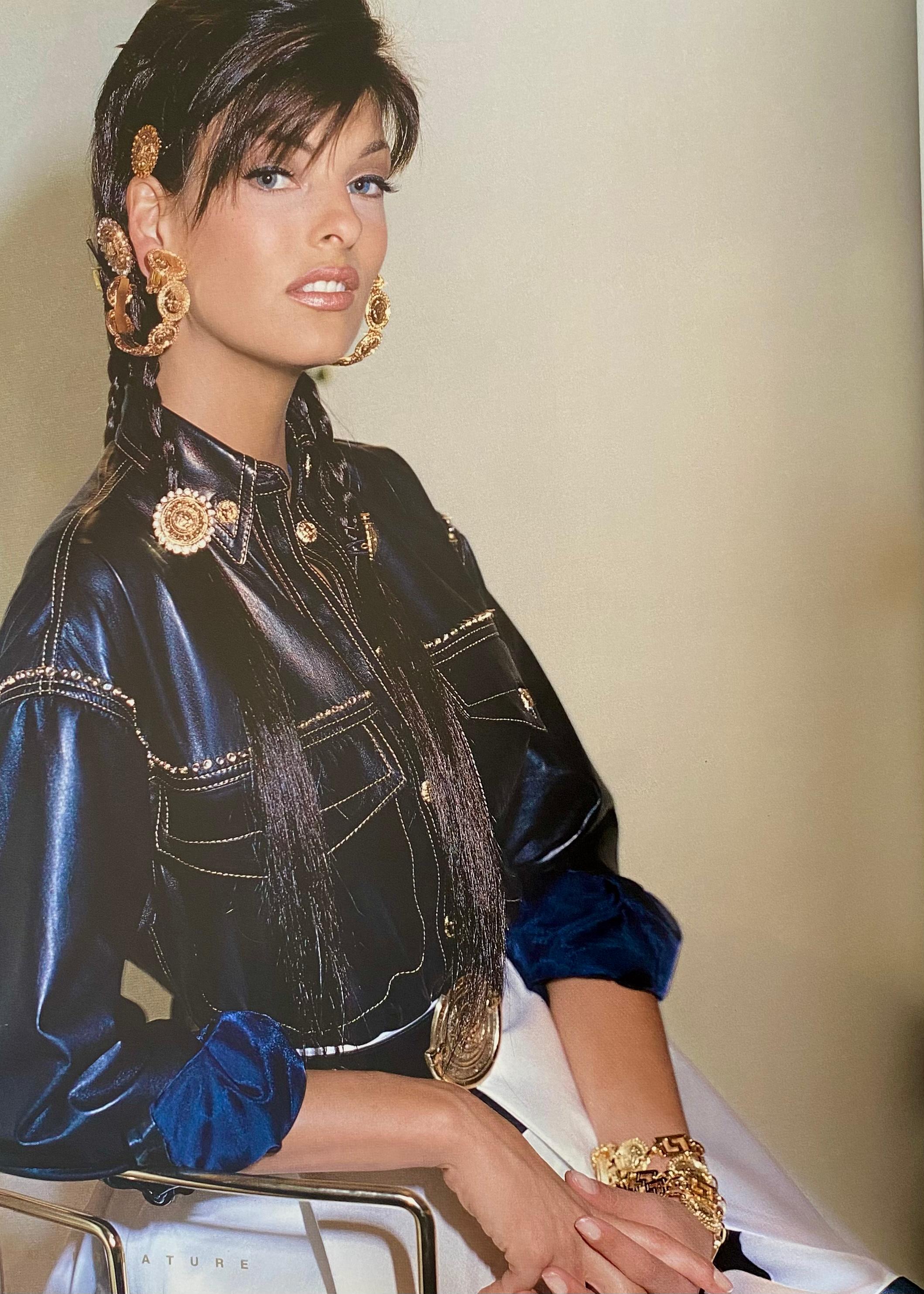 From the F/W 1992 Miss S&M ('Bondage') collection, this gorgeous rhinestone-studded leather top is nearly identical to the one seen in look 39 modeled by Marpessa Hennink in the collection's runway. This top pops with bright gold stitching and a row