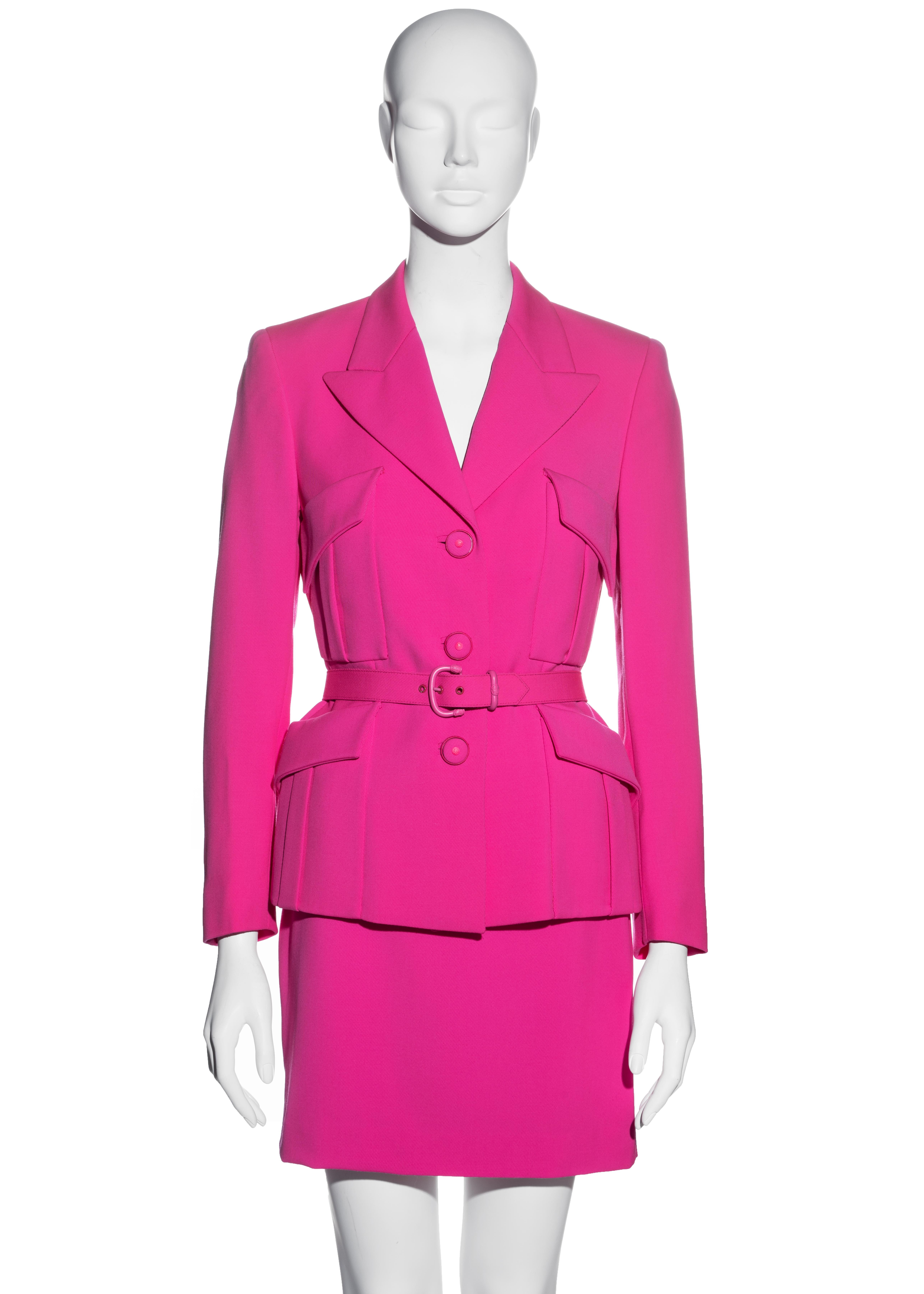 ▪ Gianni Versace neon pink wool monochromatic skirt suit 
▪ 100% Wool, Lining 100% Rayon 
▪ Single-breasted fitted blazer jacket
▪ Four front flap pockets 
▪ Matching belt with pink hardware 
▪ Fabric covered buttons with Medusa hardware 
▪ Matching
