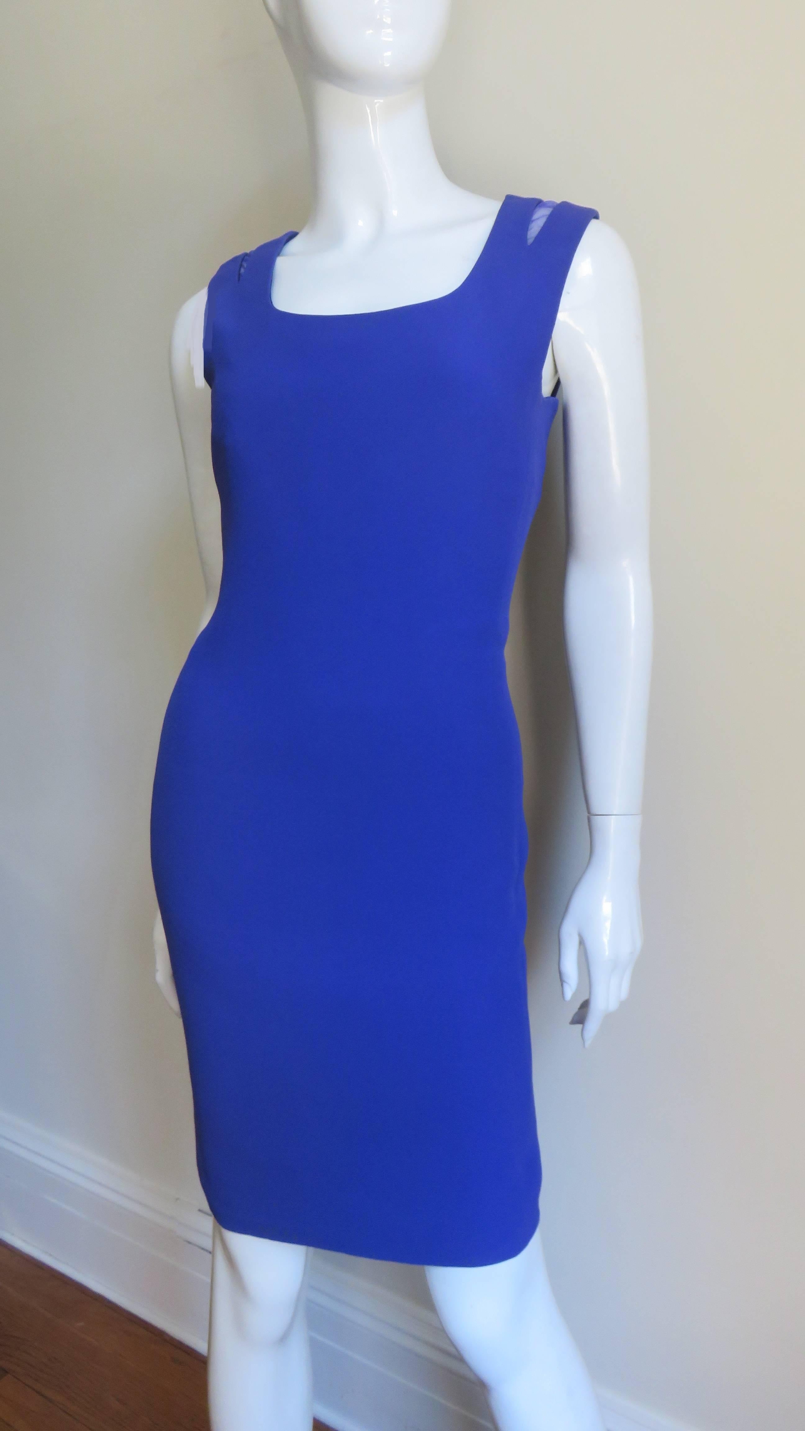 A fabulous purple dress from Gianni Versace Couture. It is semi fitted, sleeveless with a scoop neckline and matching purple mesh insets at the shoulders. The dress is fully lined in purple silk, has inner boned corset for support and a back zipper.