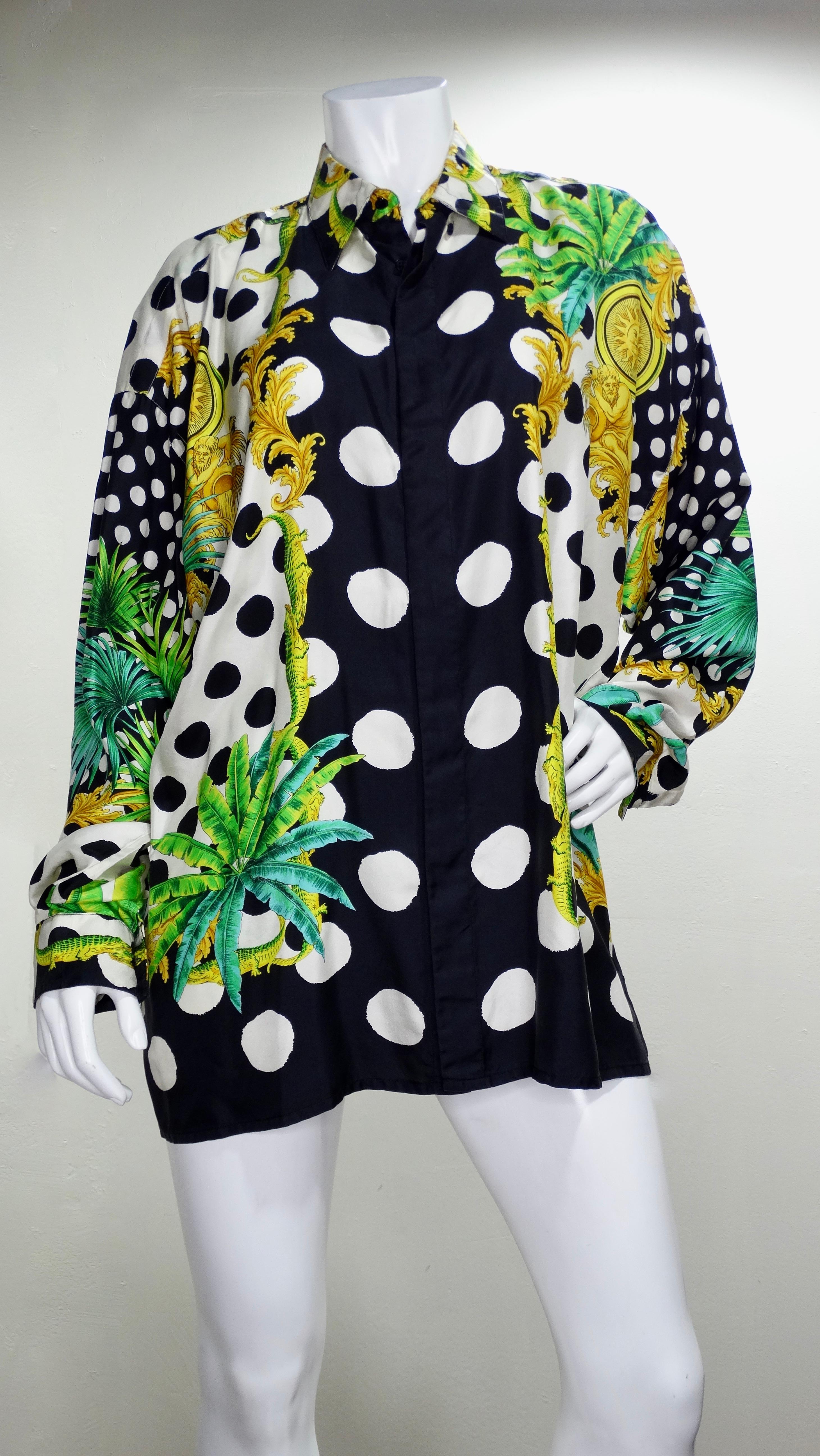 Snag yourself a piece from the Versace archives! Circa 1993, this silk shirt features a contrasting black and white polka dot motif with crocodiles, palm fronds, celestial sun medallions, and the signature Versace Baroque designs. Classic and