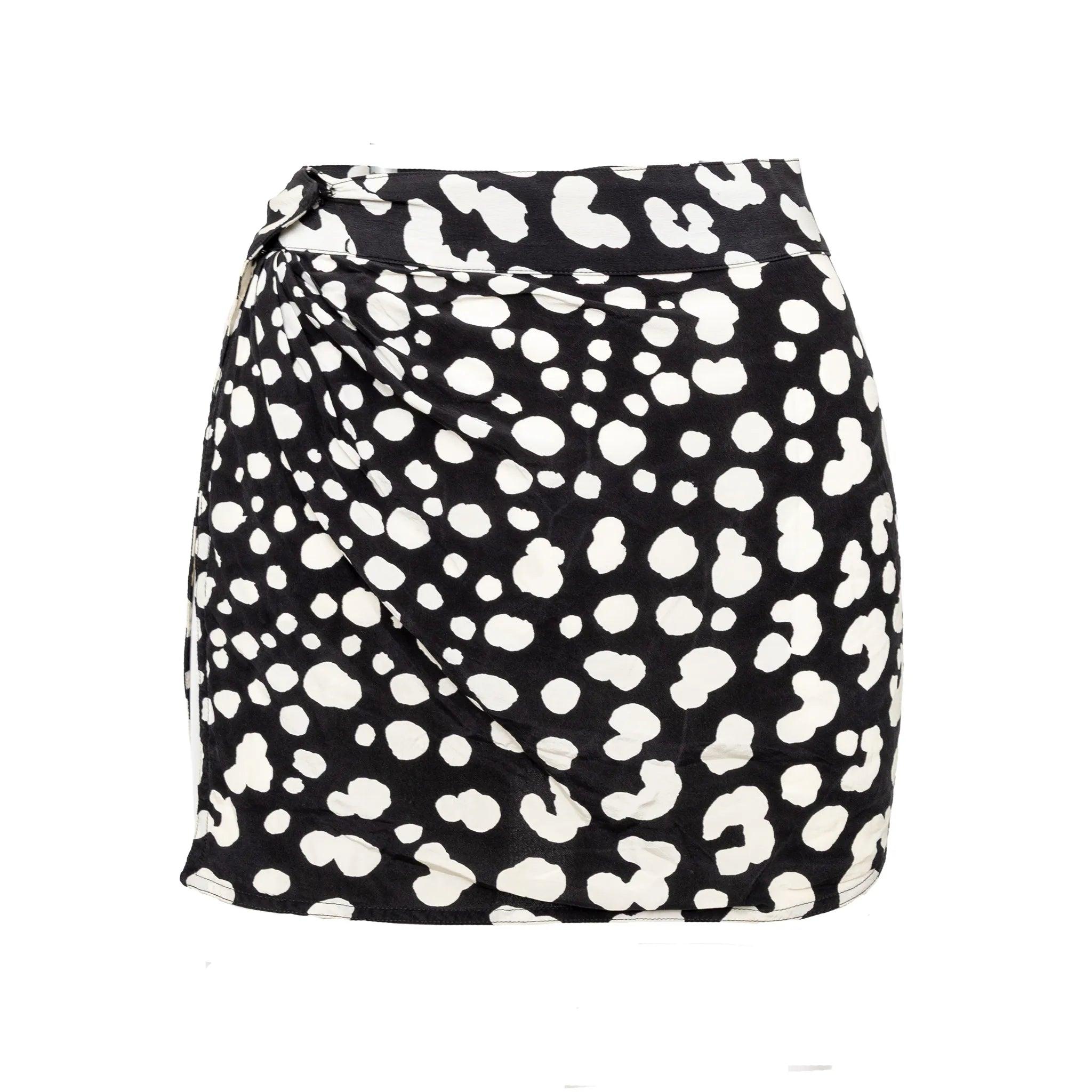 Black and white silk mini skirt in mixed polka dot and animal prints, featuring a side slit and button closure. A playful statement, many ways to style. Remarks: The size is not indicated. 
 Material: 100% Silk 
 Measurements: Waist:30.5;Length:40