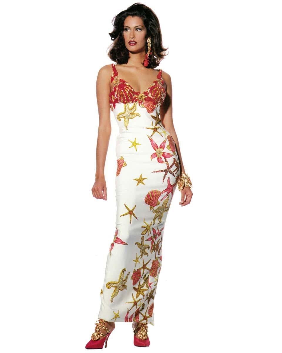 Gianni Versace printed silk and beaded 'Sea Shell' dress. Silk crêpe sheath printed with pink and gold sea-shells and star fish, the be-jewelled breast cups and straps in the form of red rhinestone, sea anemones and star fish. Look 50 on the