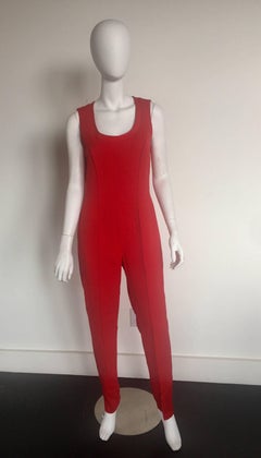 Gianni Versace red jumpsuit and matching glasses cropped bolero jacket