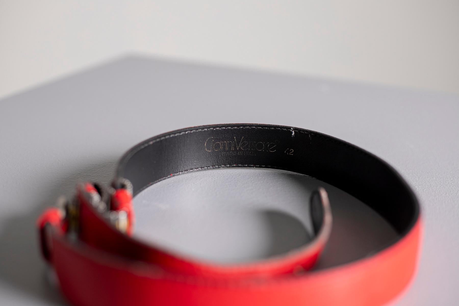 Beautiful red leather belt by Gianni Versace, Made in Italy. Really special piece to make your outfit more sophisticated. The belt is made of a soft leather and has details on the left side in gold and silver metal. Inside we find the Gianni Versace