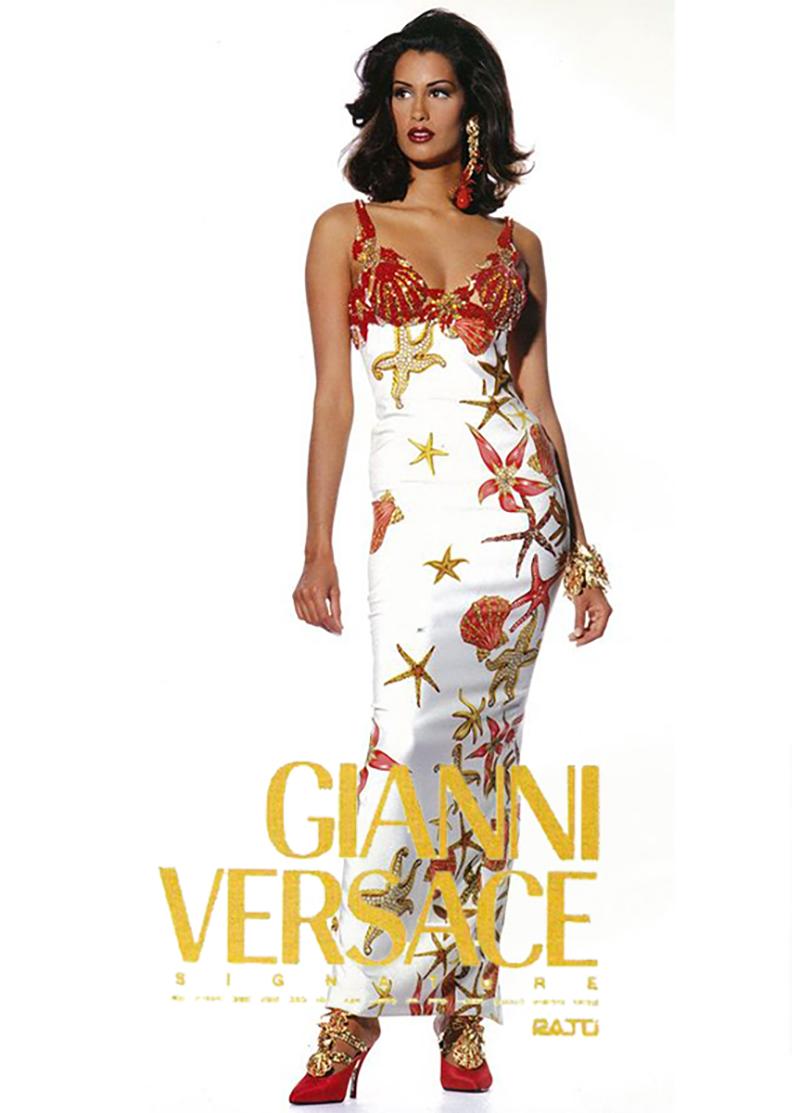 - Designed by Gianni Versace 
- Sold by Skof.Archive
- Runway Look 50
- Silk crêpe sheath printed with pink and gold sea-shells and star fish 
- Be-jewelled breast cups and straps in the form of red rhinestone, sea anemones and star fish 
- Fully