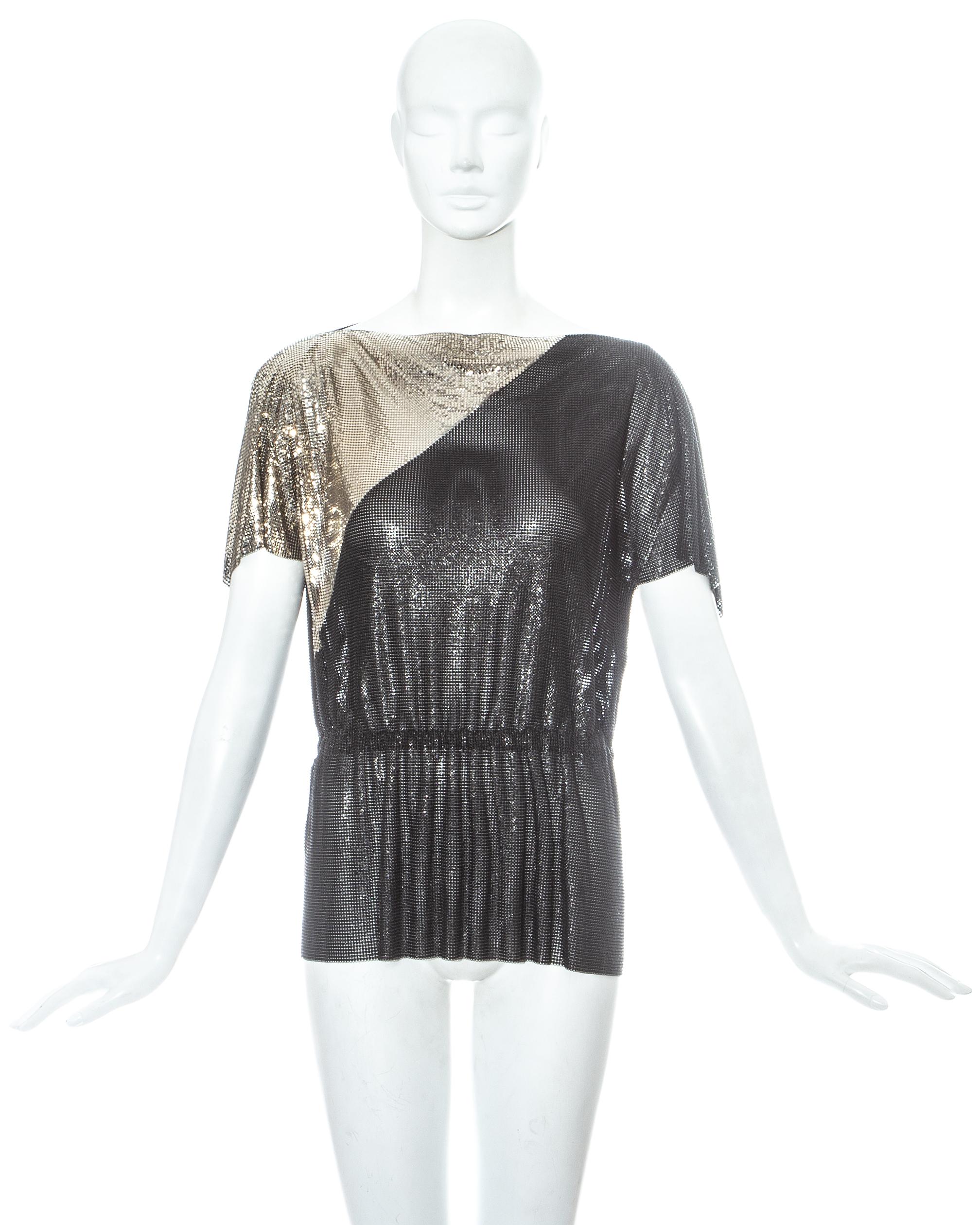 Gianni Versace silver and grey proton chainmail metal mesh top with draped sleeves and elasticated waistband.

Fall-Winter 1983