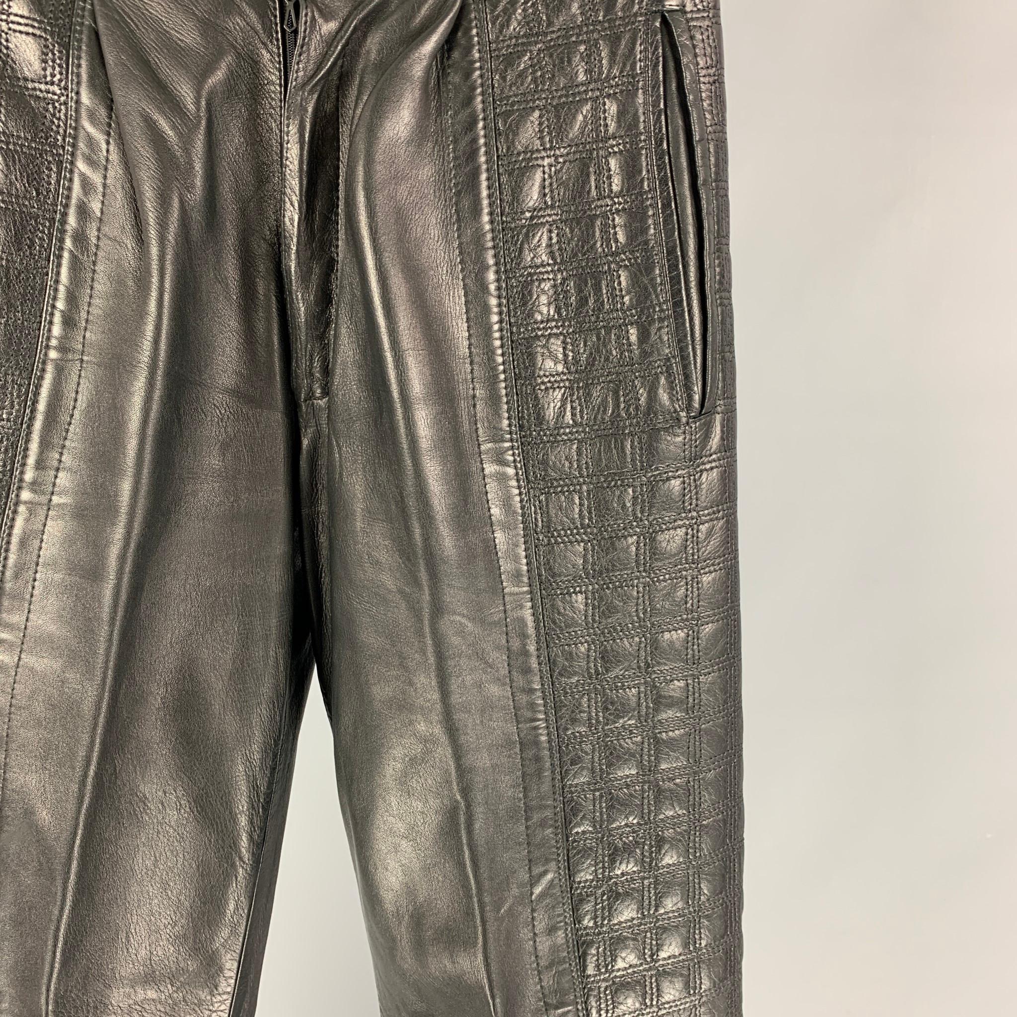 GIANNI VERSACE casual pants comes in a black quilted leather featuring top stitching, pleated front, slit pockets, and a zip fly closure. 

Very Good Pre-Owned Condition. Fabric tag removed.
Marked: Size tag removed.

Measurements:

Waist: 29