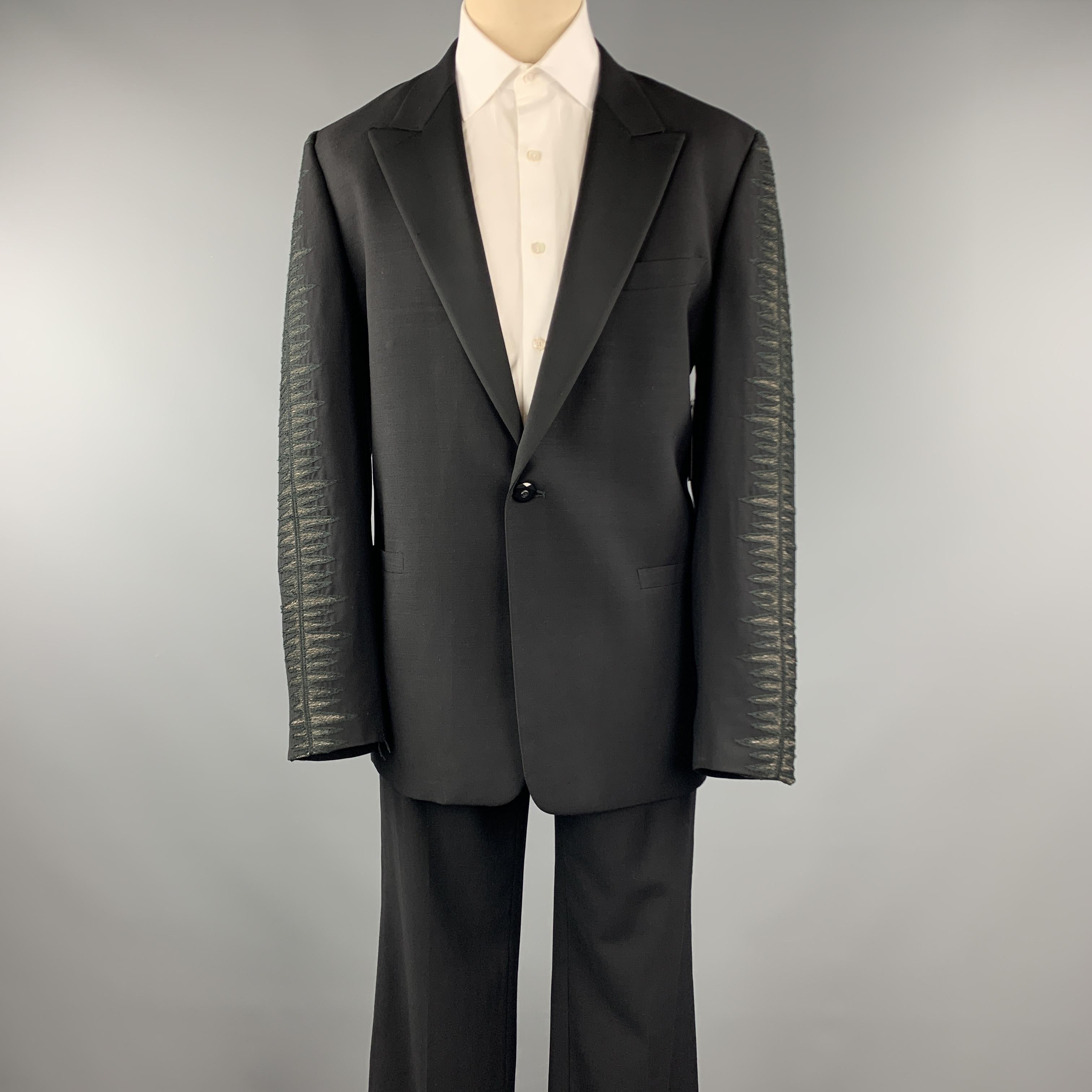 VINTAGE GIANNI VERSACE suit comes in a black wool featuring a tuxedo style, sleeve embroidered details, peak lapel, single button closure, and matching flat front trousers. Made in Italy. 
 

Excellent Pre-Owned Condition.
Marked: IT