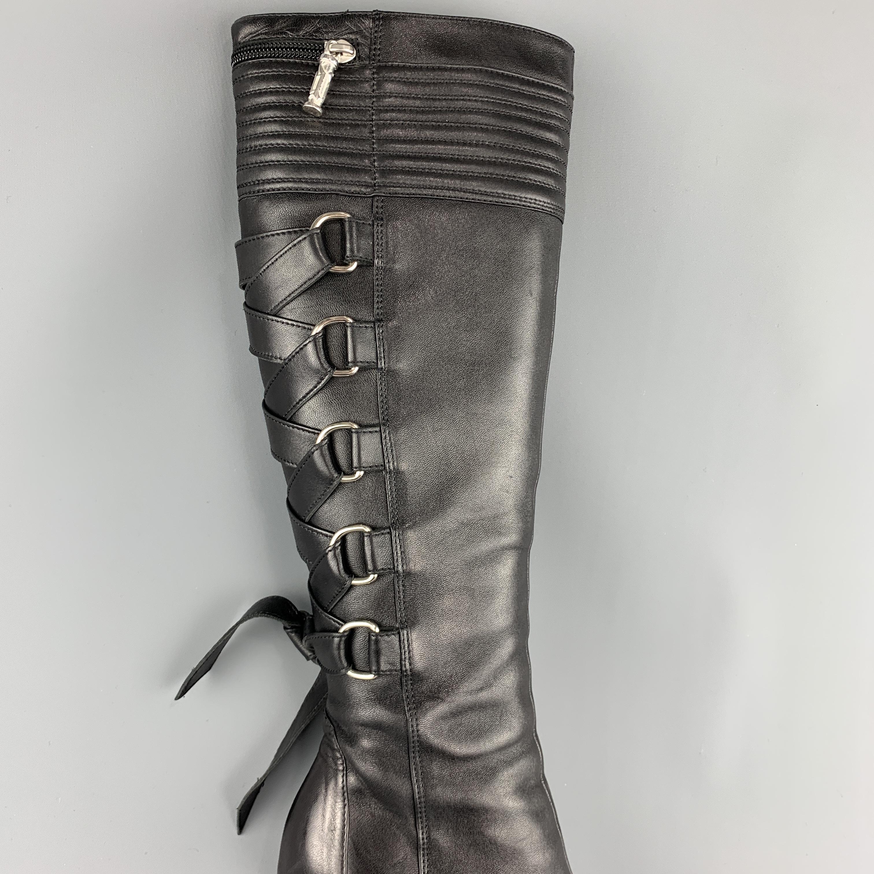 GIANNI VERSACE Knee high bondage boots come in smooth black leather with a quilted top panel, pointed toe, stacked stiletto heel, and iconic Fall 2003 D ring corset lace up back. Made in Italy.
 
Excellent Pre-Owned Condition.
Marked: IT 38
