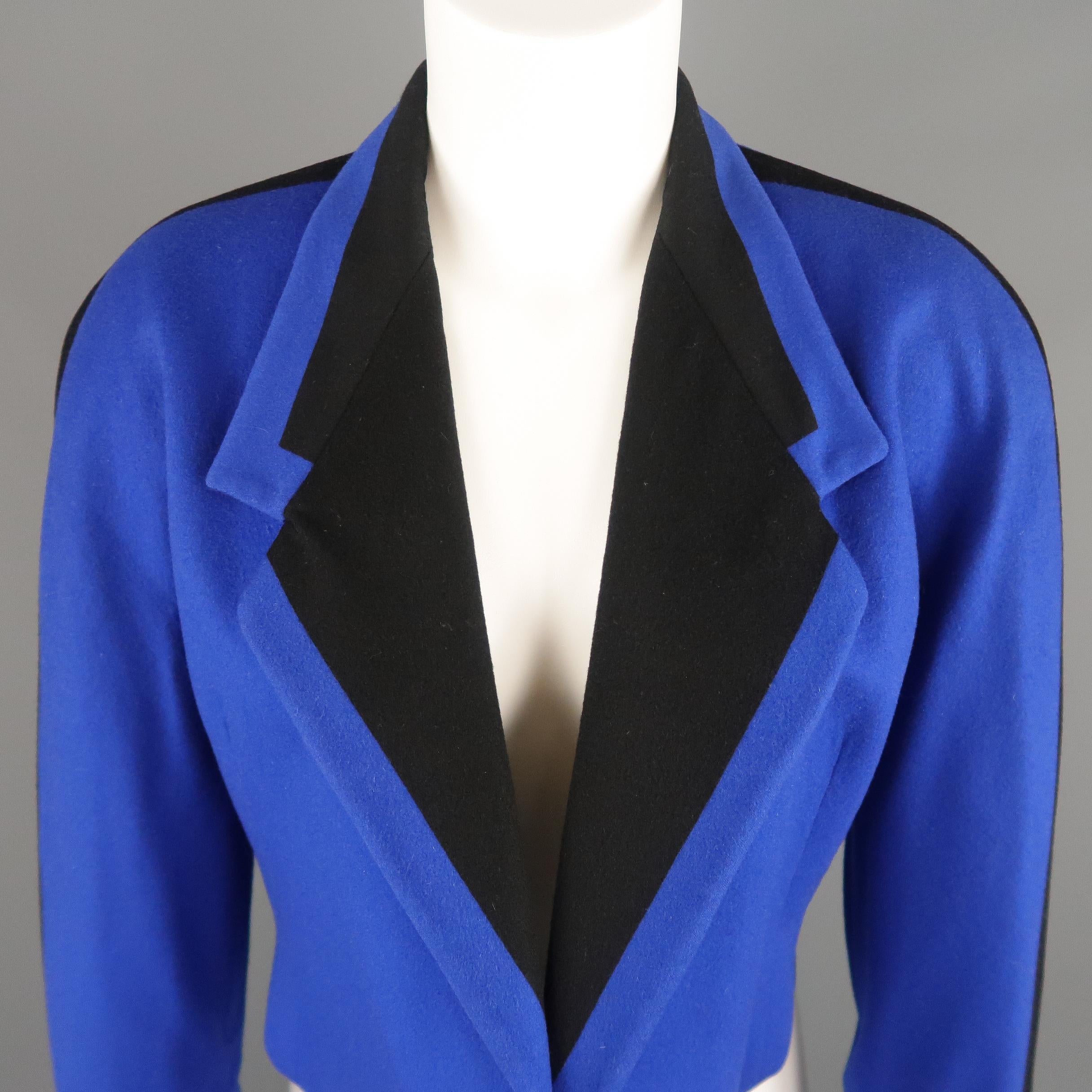 Vintage GIANNI VERSACE jacket comes in royal blue wool with black color block and stripe pattern, cropped hem, and open front. Made in Italy.
 
Very Good Pre-Owned Condition.
Marked: IT 42
 
Measurements:
 
Shoulder: 21 in.
Bust: 42 in.
Sleeve: 23