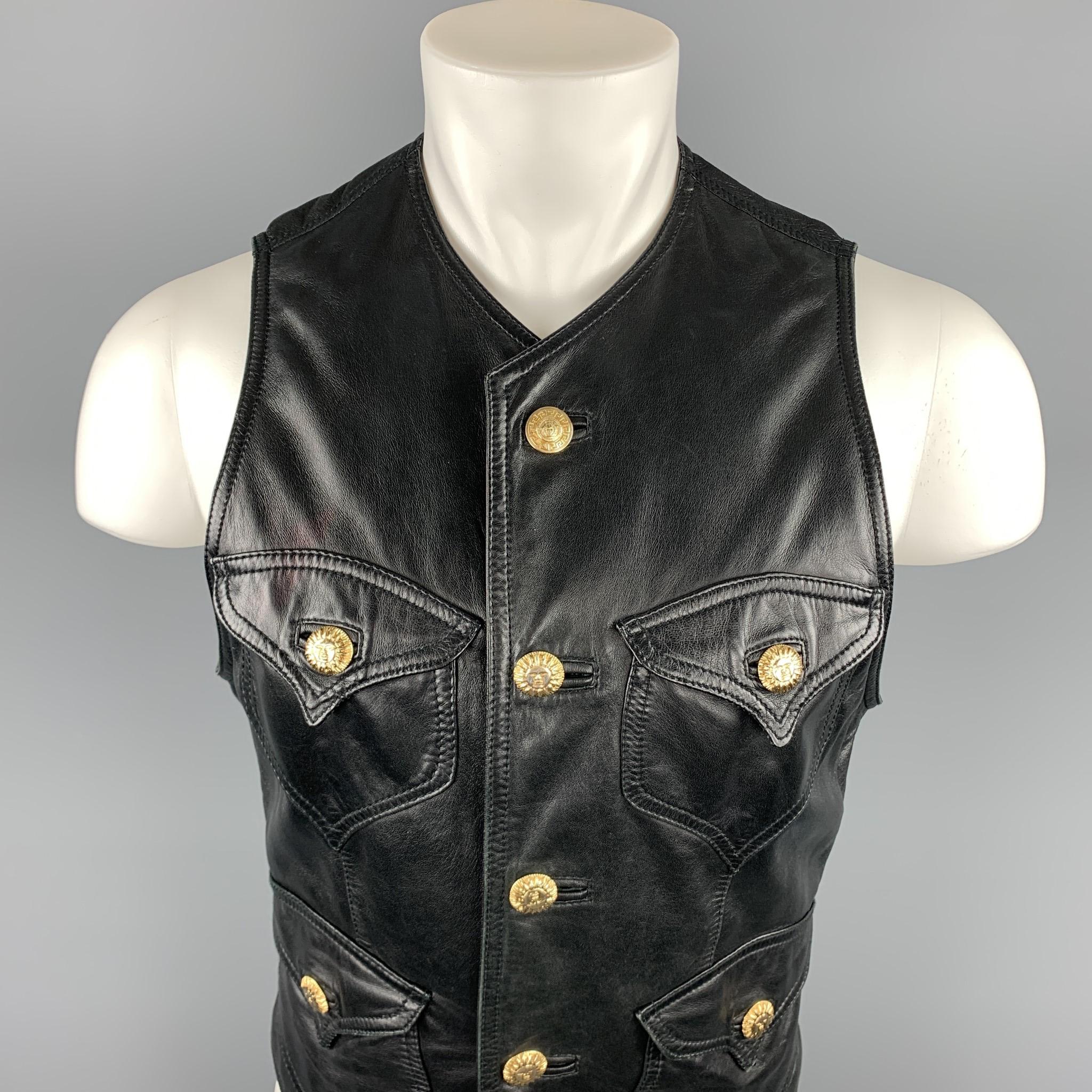 GIANNI VERSACE vest comes in a black leather featuring gold sun buttons, front pockets, and a v-neck. As-Is. Has been altered, and back belt has been removed. Made in Italy.

Good Pre-Owned Condition.
Marked: No size marked