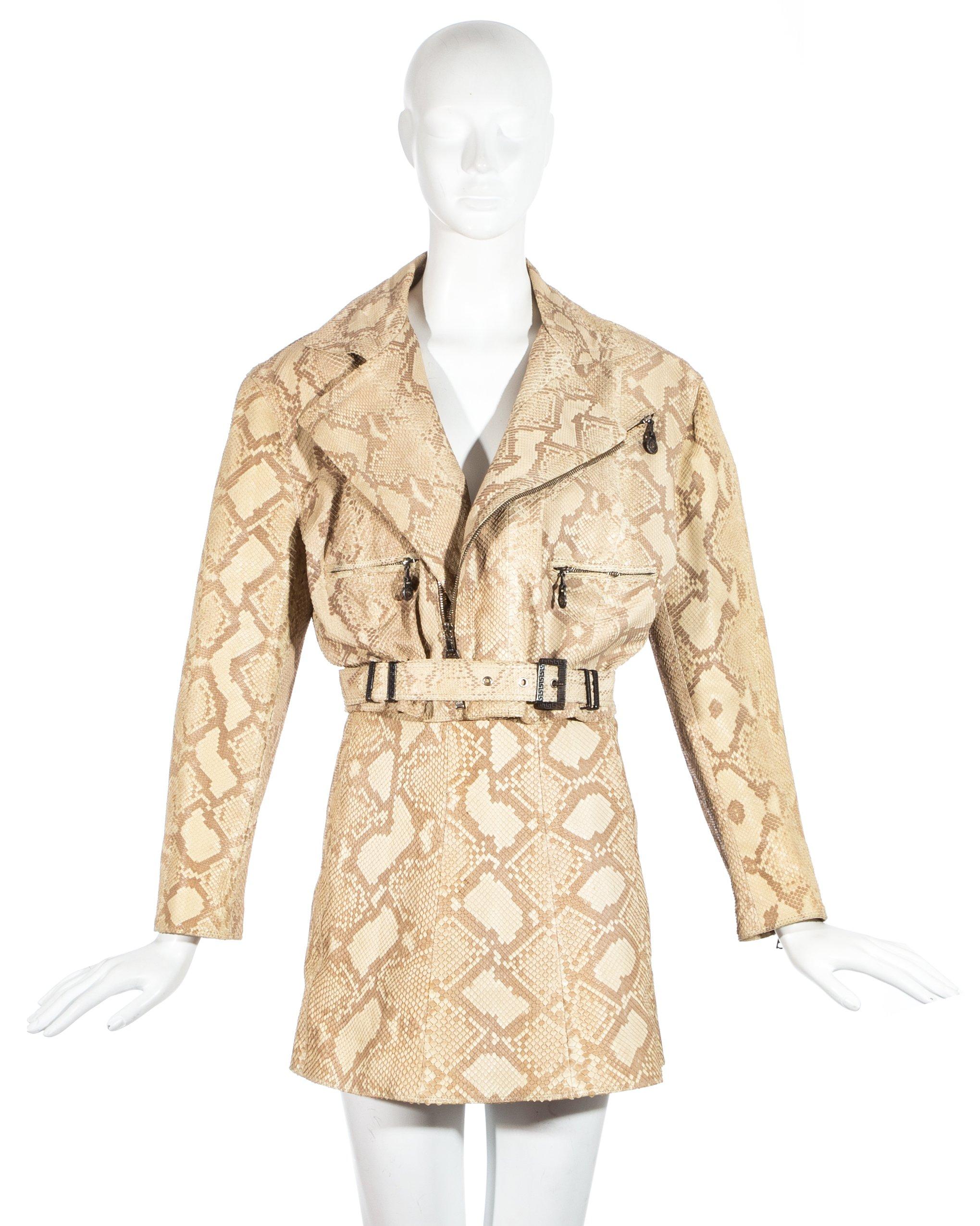 Gianni Versace; cream snakeskin leather biker jacket and mini skirt. Cropped biker jacket with silk Medusa lining and metal buckle and zip fastenings. High waisted A-Line mini skirt with zip fastening.  

Fall-Winter 1994