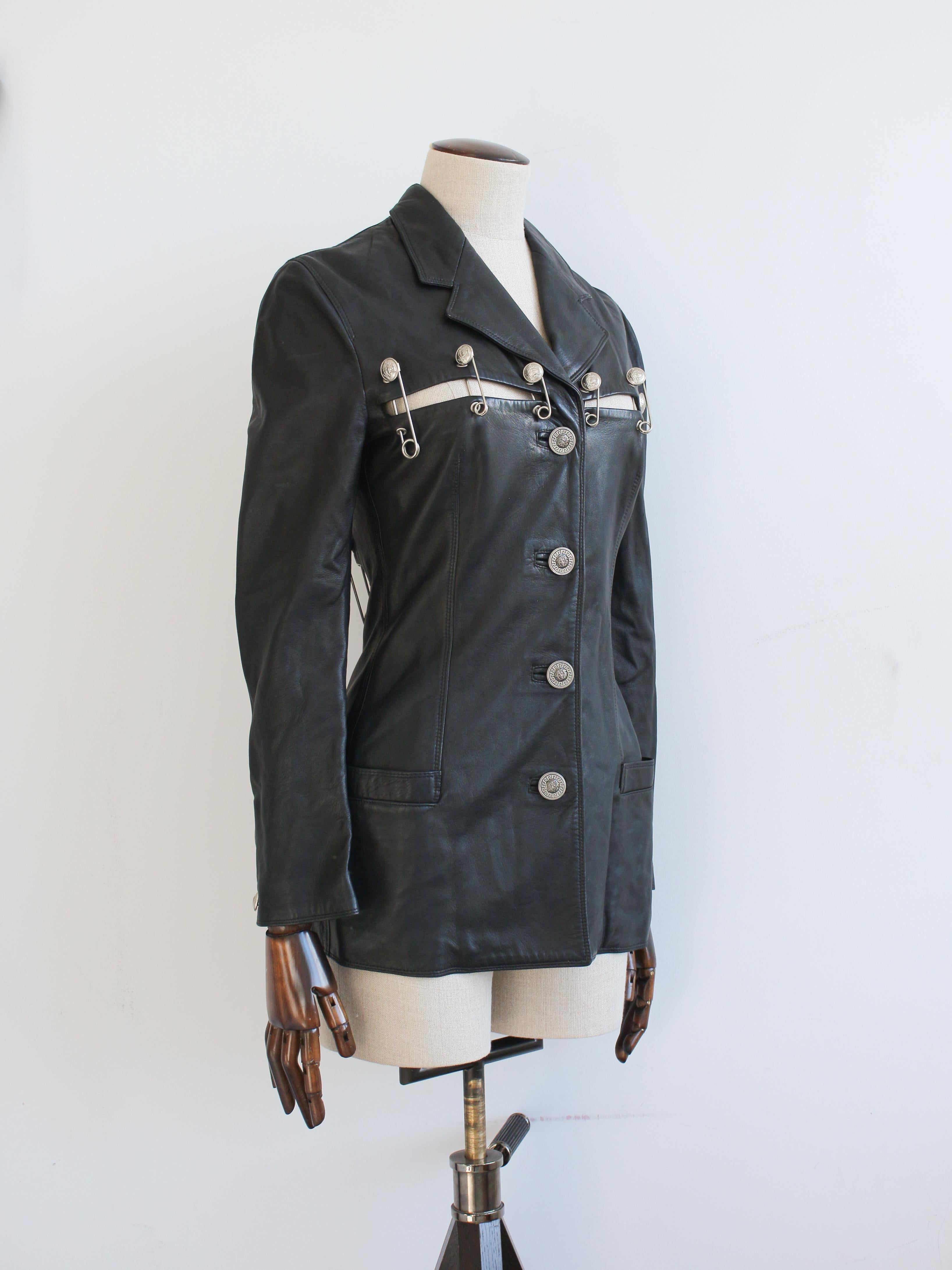 Veste en cuir Gianni Versace printemps/été 1994 avec épingles à nourrice méduses argentées de taille variable.

Présenté sur le podium en laine froissée.

Entièrement doublé avec des boutons en méduse.

La veste est en bon état avec une certaine