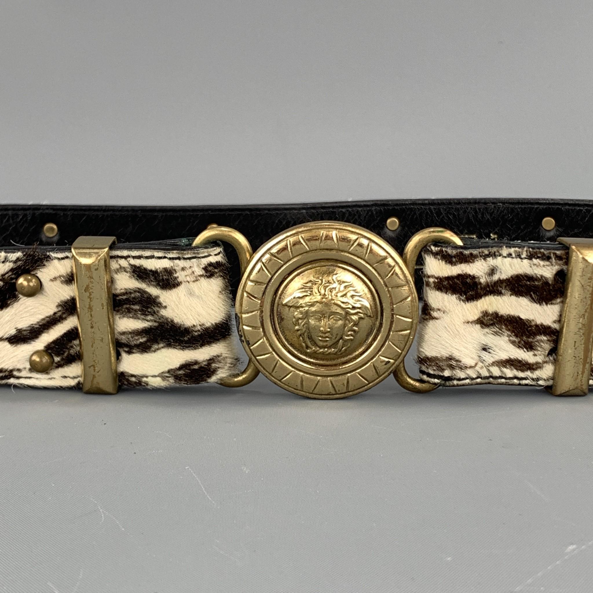 Vintage GIANNI VERSACE belt features a brown and cream zebra print ponyhair leather strap with gold tone Medusa head studs and round Medusa head buckle. Made in Italy.

Very Good Pre-Owned Condition.
Marked: 80/32  081

Length: 32 in.
Width: 1.5 in.