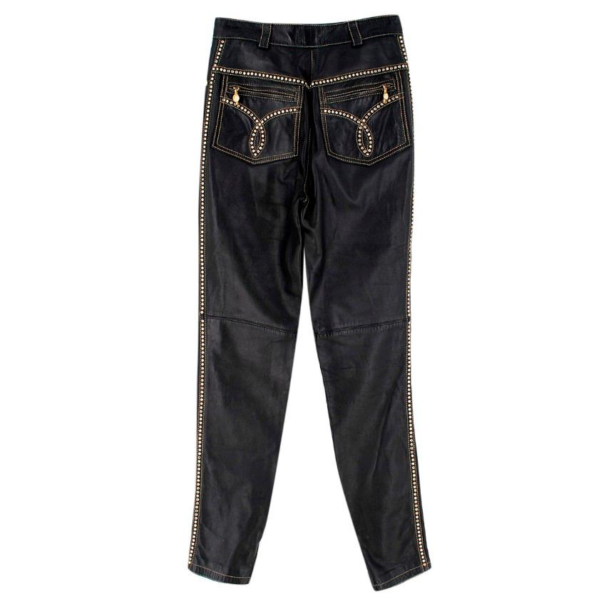 Gianni Versace Studded Leather Trousers

- Black leather trousers
- Skinny leg
- High rise
- Contrast stitching
- Four pocket design
- Belt loops
- Concealed zip fastening
- Zipped cuffs
- Rhinestone stud detailing

Please note, these items are