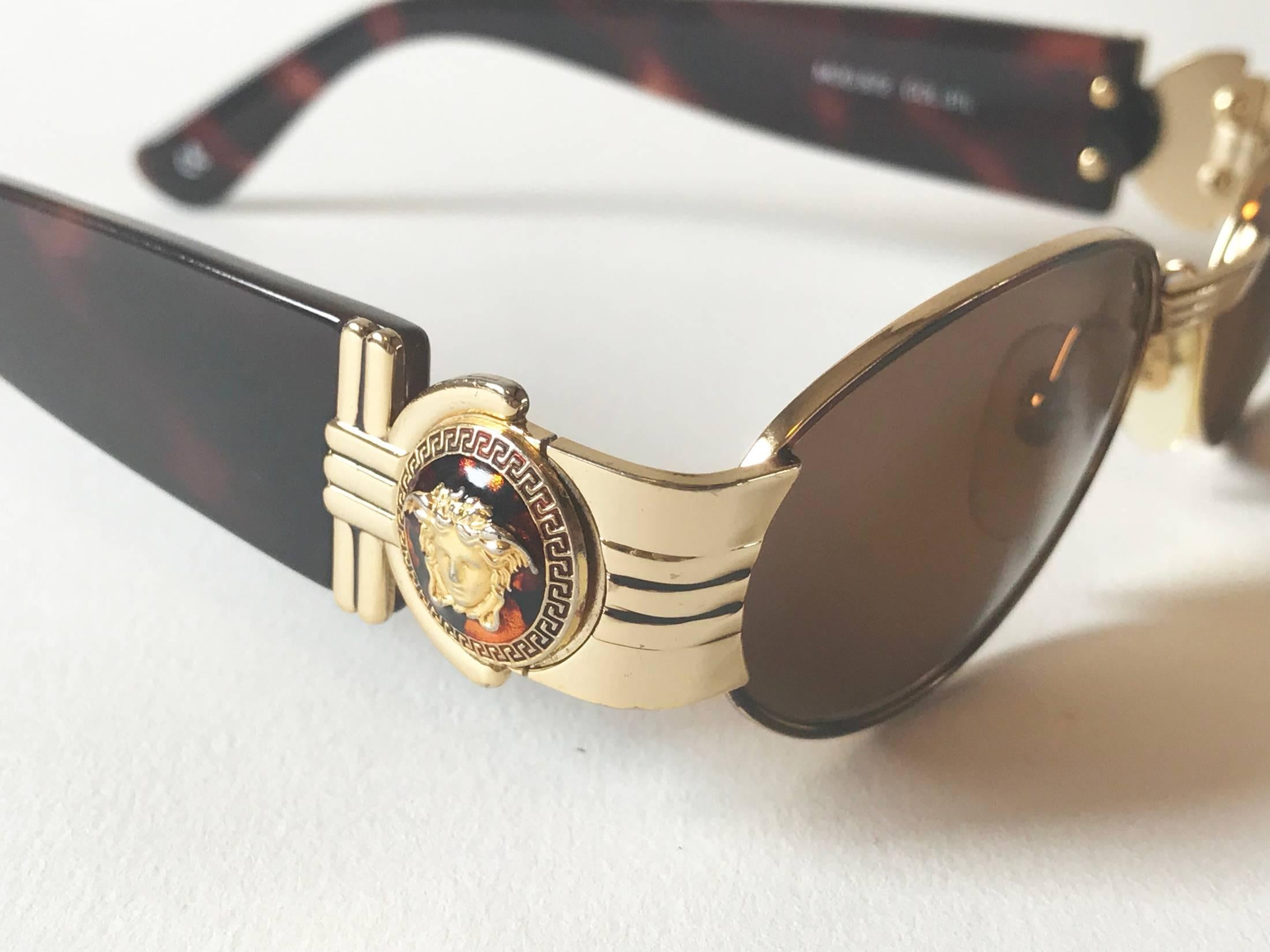 Luxury Iconic Gianni Versace Sunglasses. Mod. S72 Col. 31L, frame is  varnish turtle colour and gold plated metal, the arms are bakelite turtle colour and the lenses are brown colour matching  the frame. Medusa logo is on both sides of the glasses.